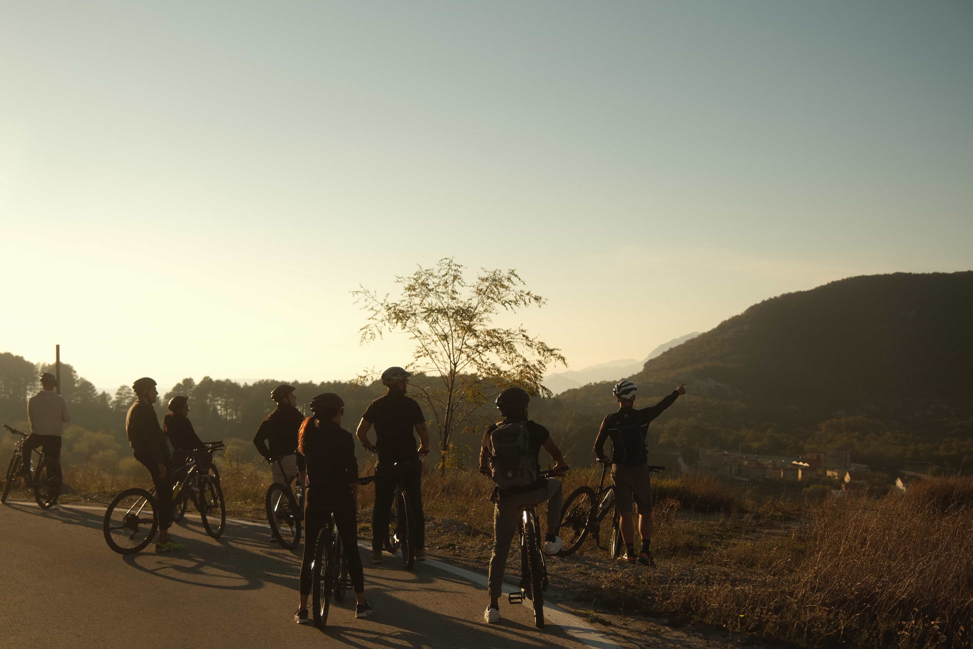 A group of people cycling with mountain views