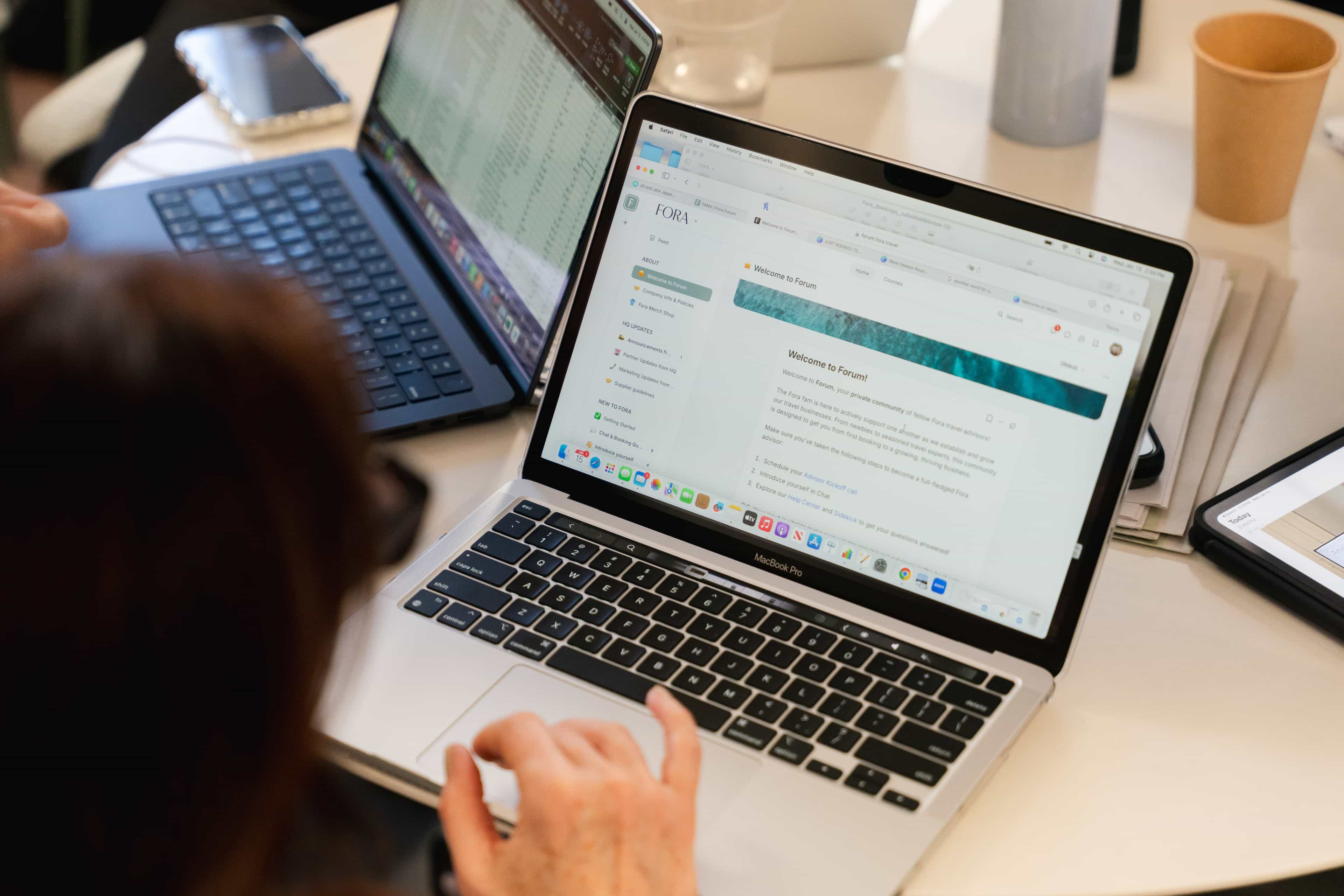 a woman uses her laptop at a table