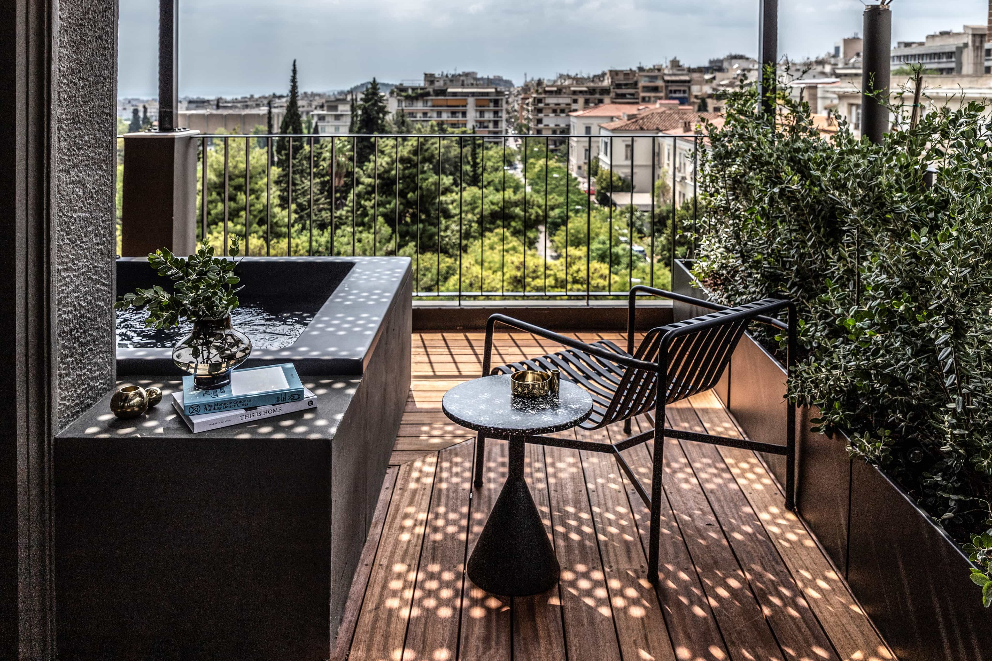 Hotel terrace with wooden deck, plunge pool and city views
