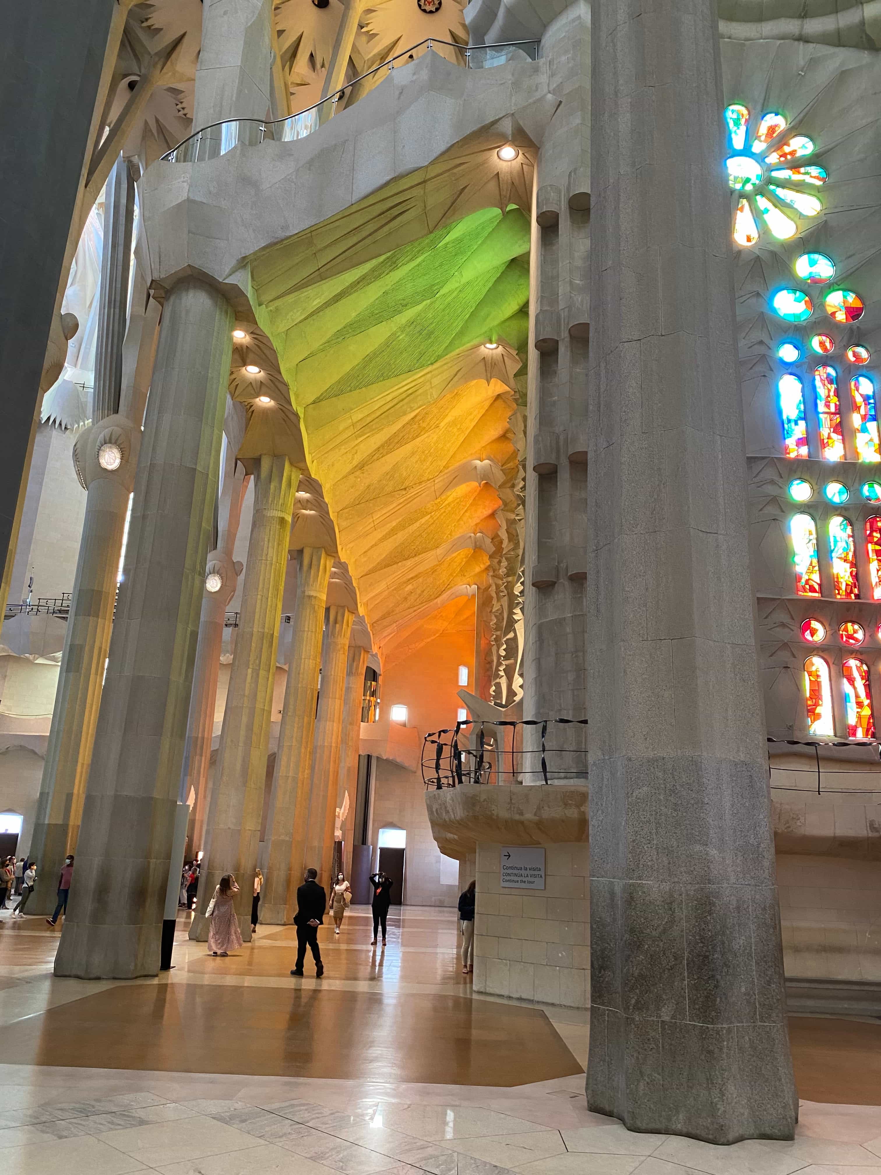 View of the inside of a grand cathedral with colorful stained glass windows