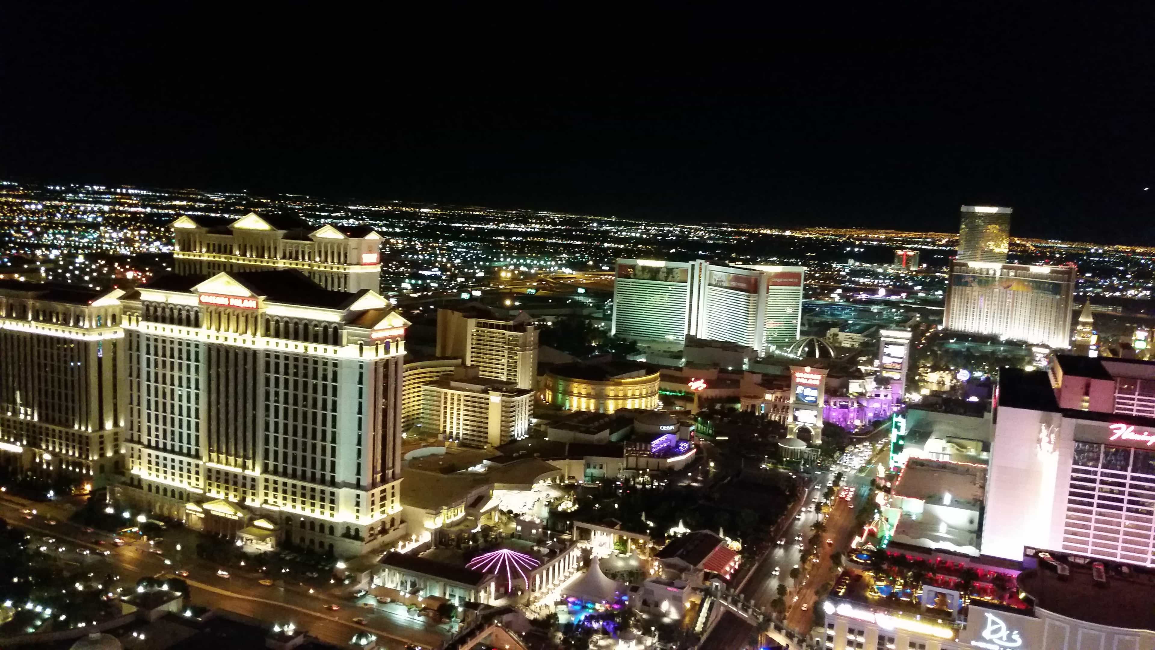 A view of a city at night with all the lights lit up. 