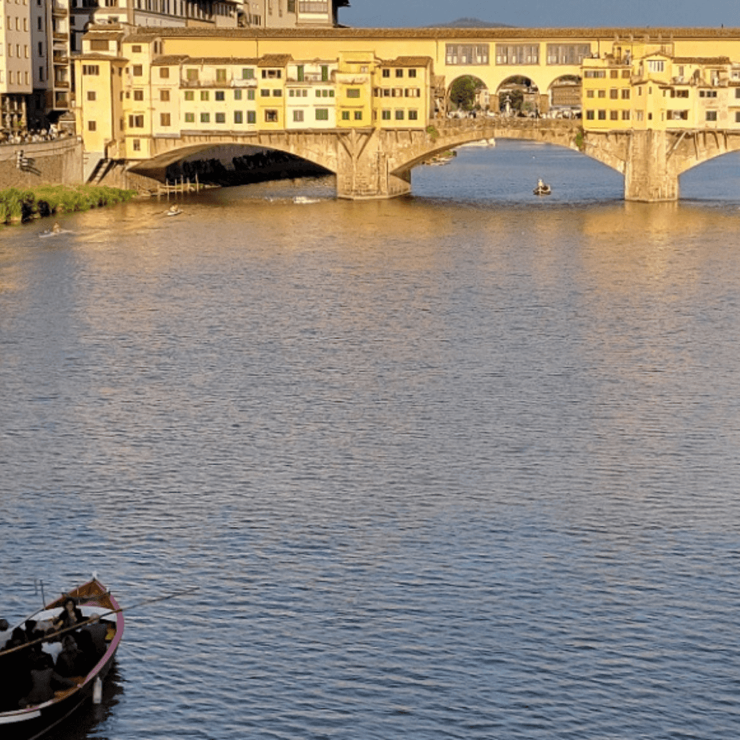 View of a bridge across a wide river glowing in the light of sunset