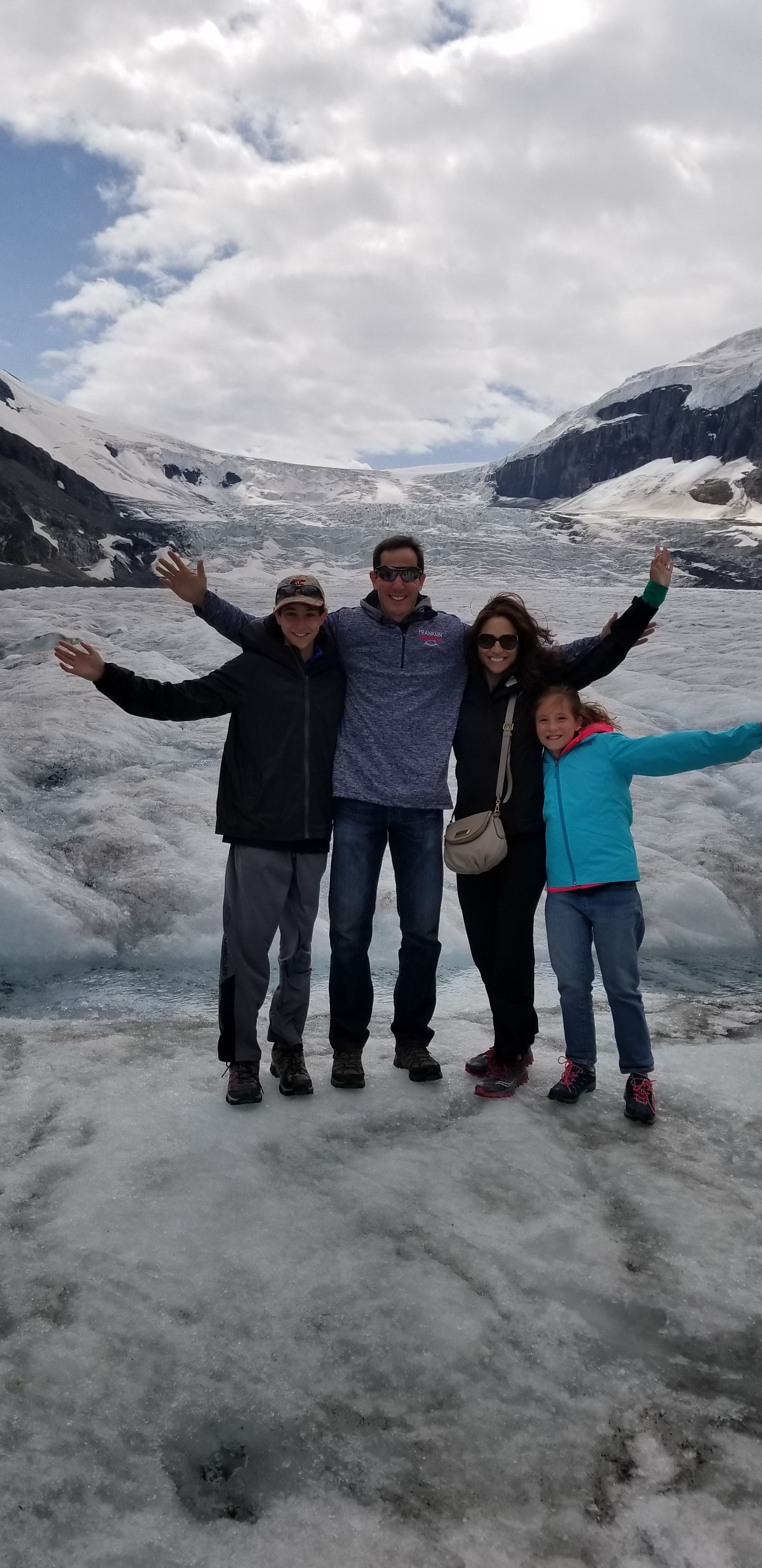 A family posing in icy landscape.