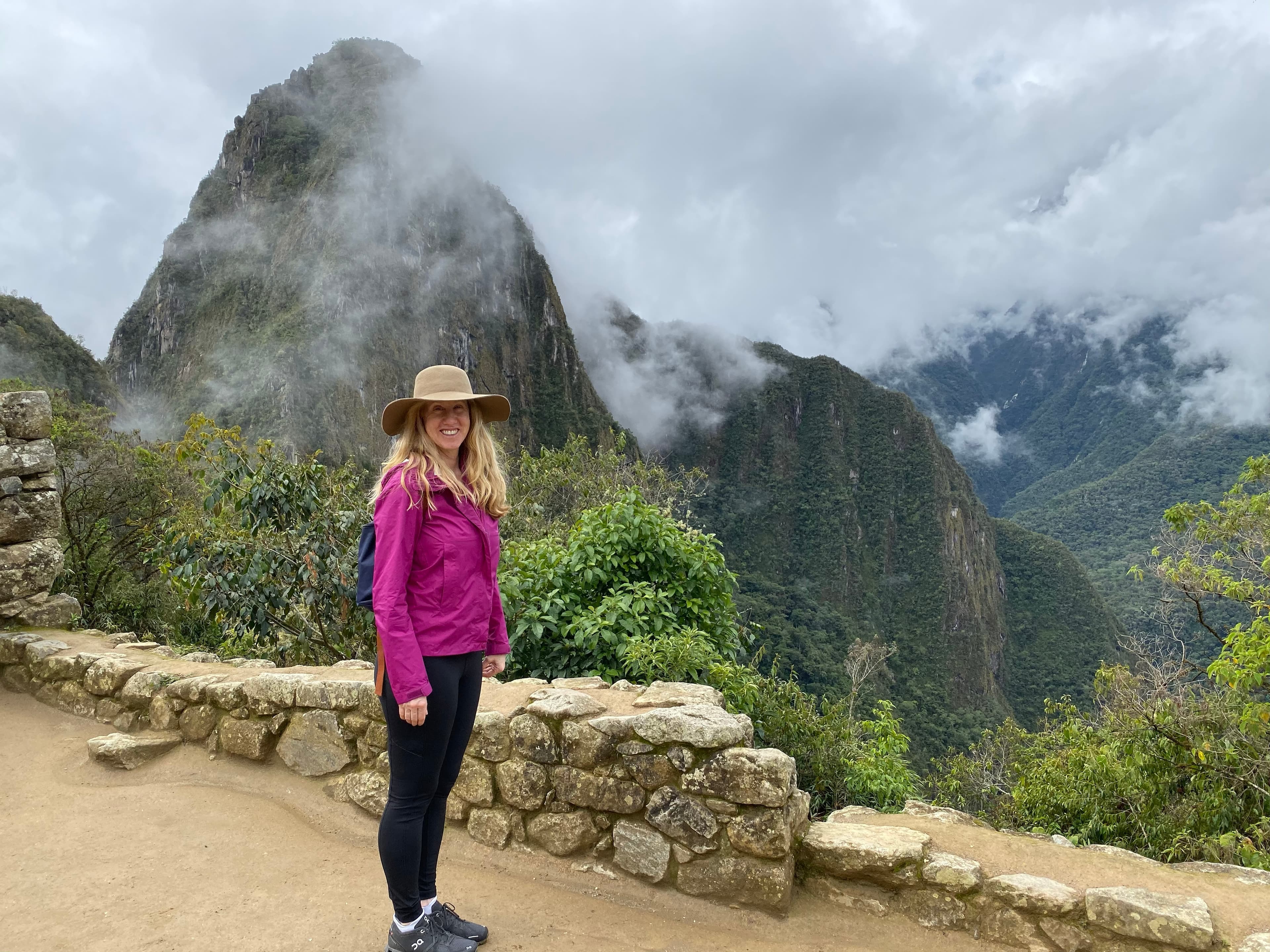 Advisor on a hike through a stunning mountain landscape filled with low-hanging clouds