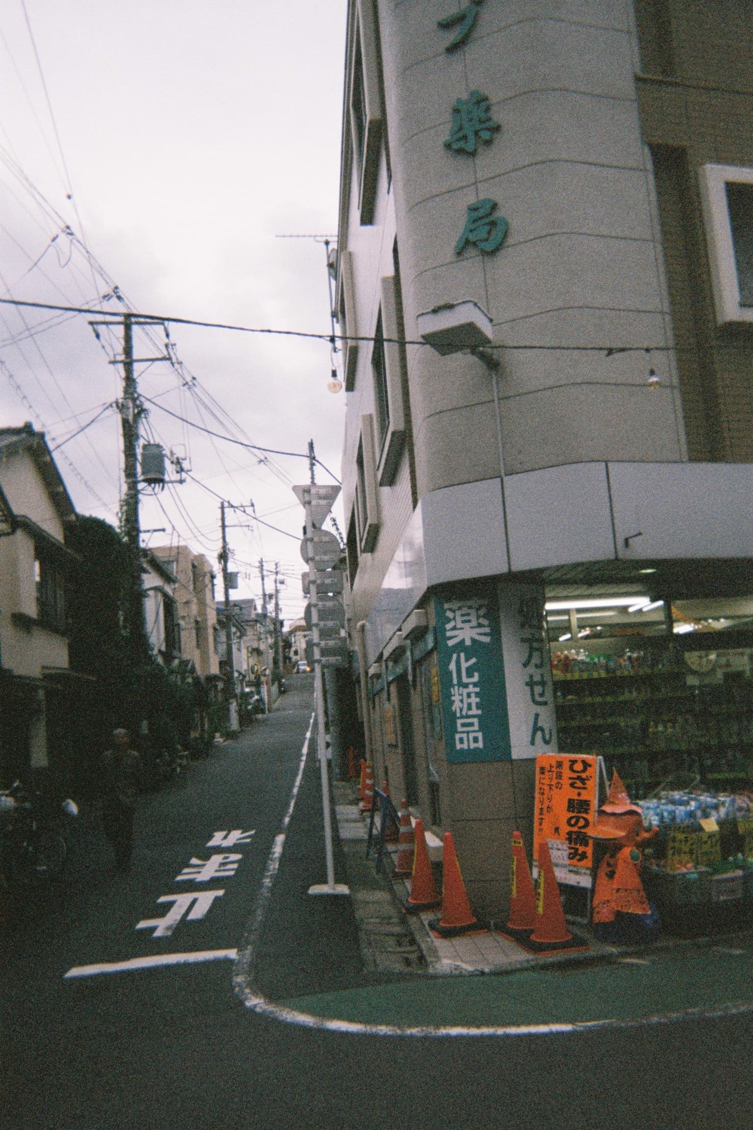 View of an empty city street corner under overcast skies