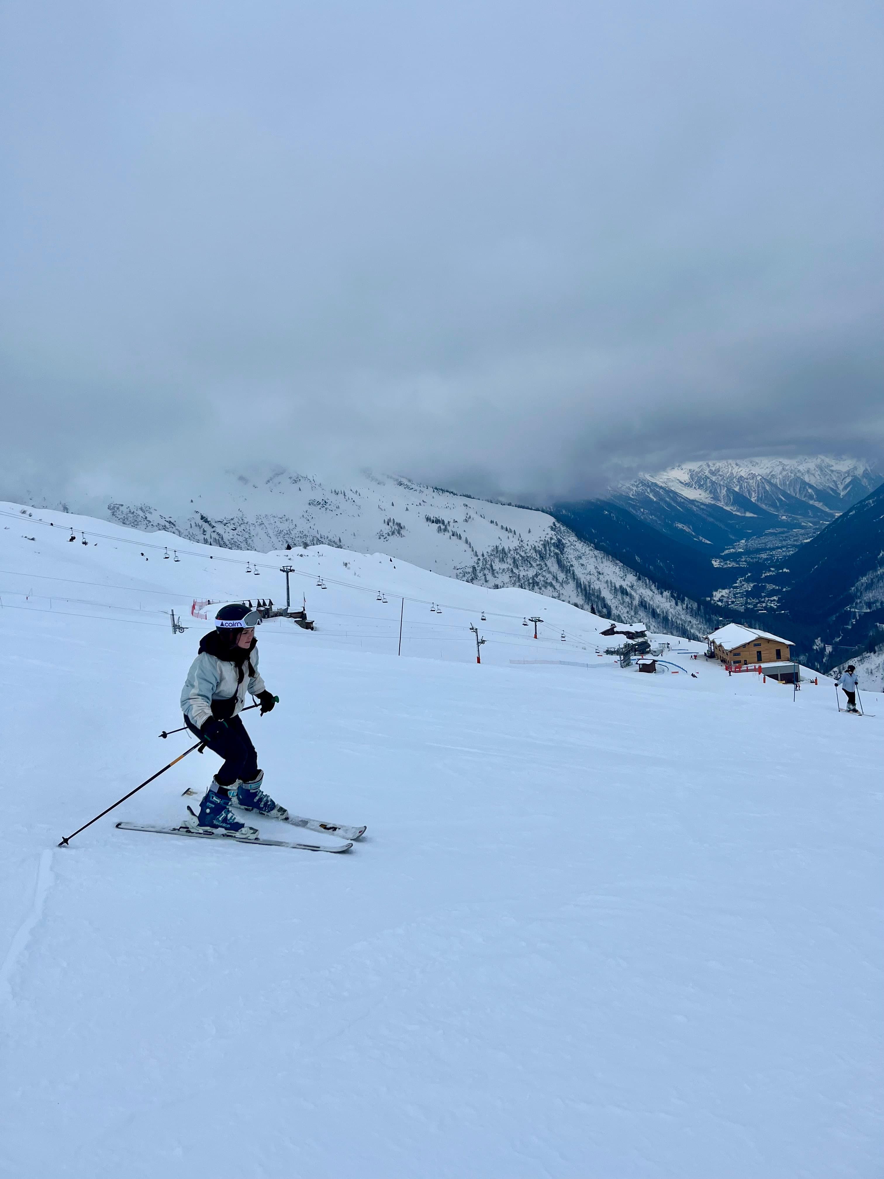 Advisor skiing down a slope in the snow.