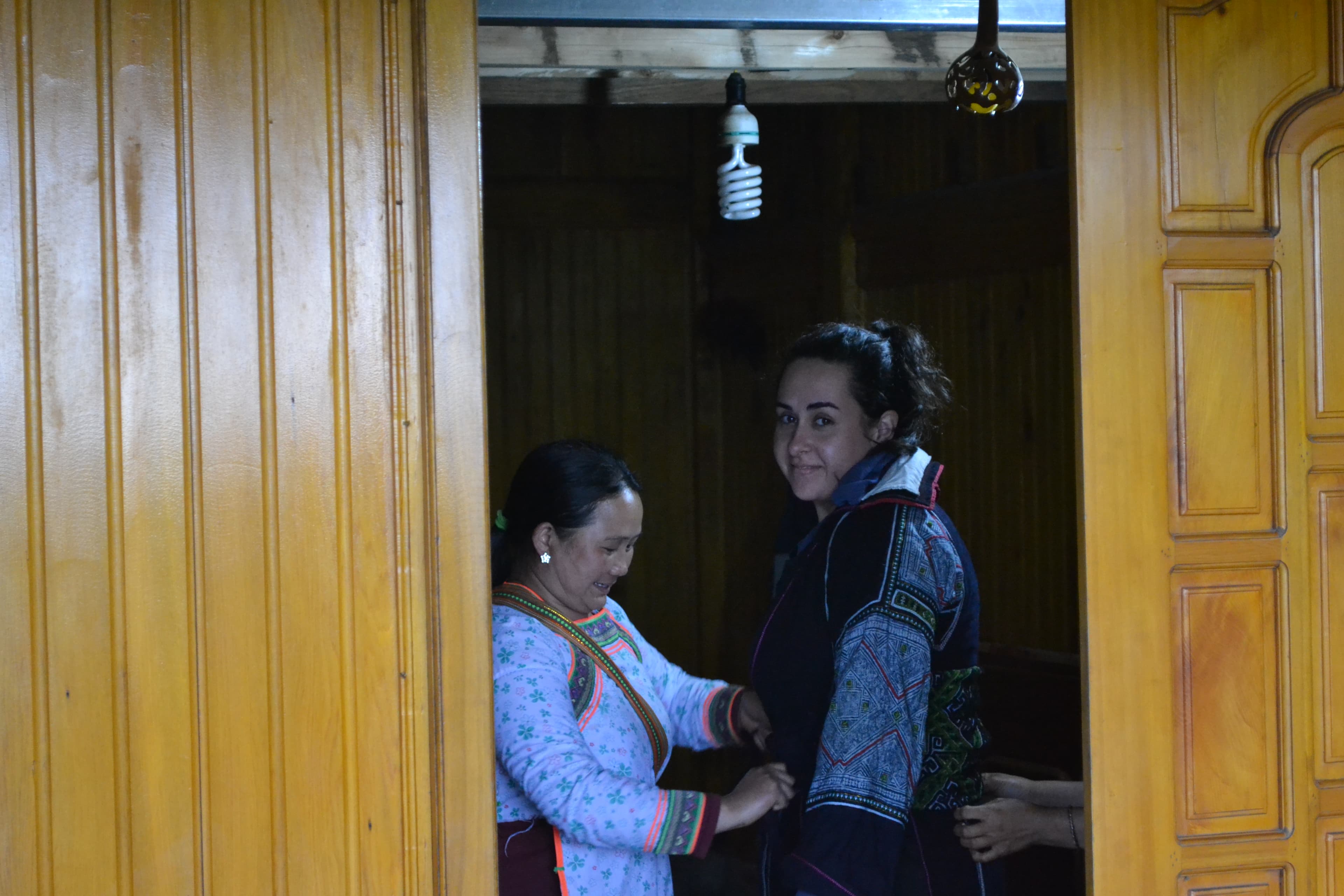 View of advisor being dressed in local clothing by another woman