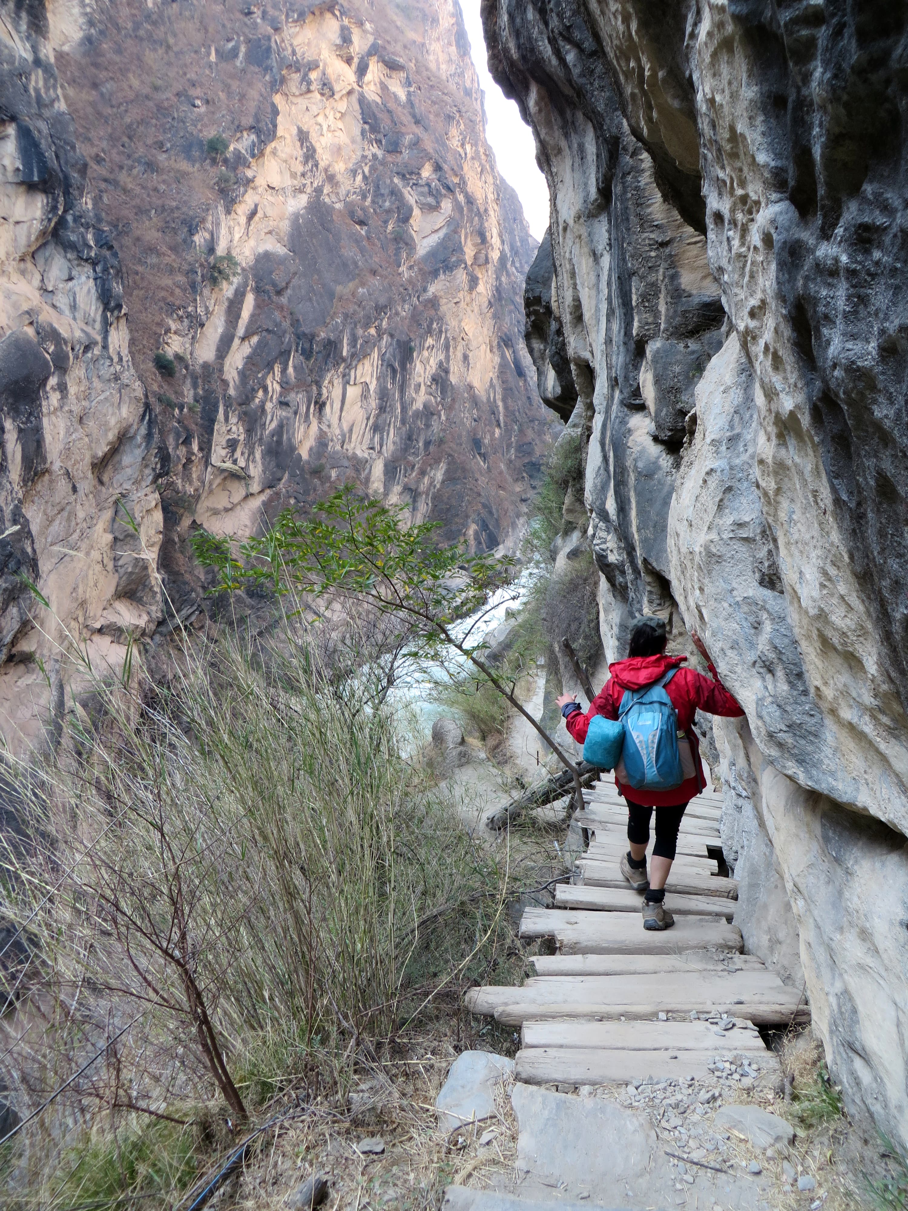 View of advisor walking down steep stone steps on the side of a mountain hike