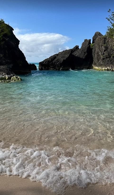 View of a beautiful ocean and nearby cliffs on a sunny day
