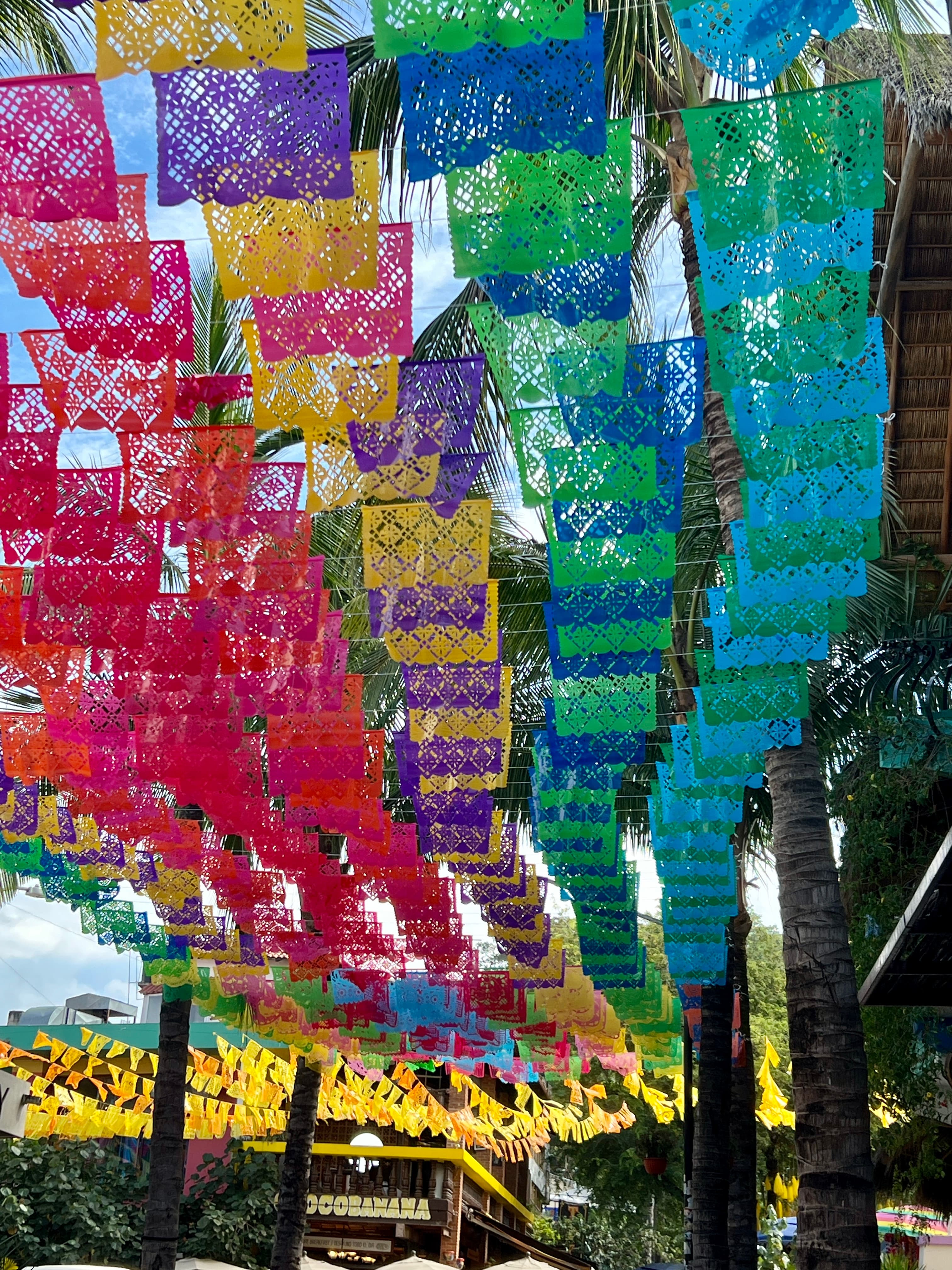 View of colorful flags hanging over a street