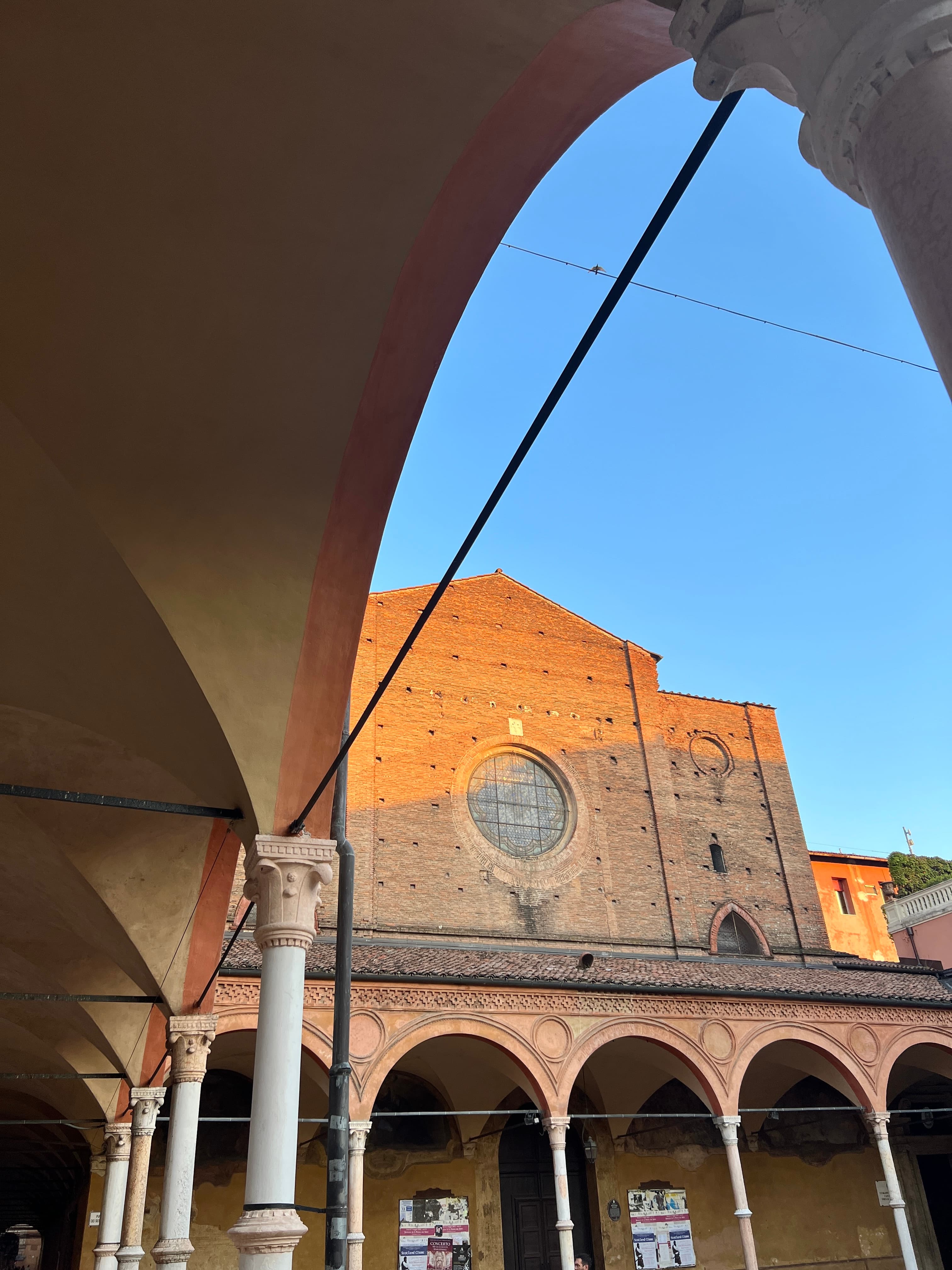 View of a beautiful building with a courtyard lined with archways on a sunny day