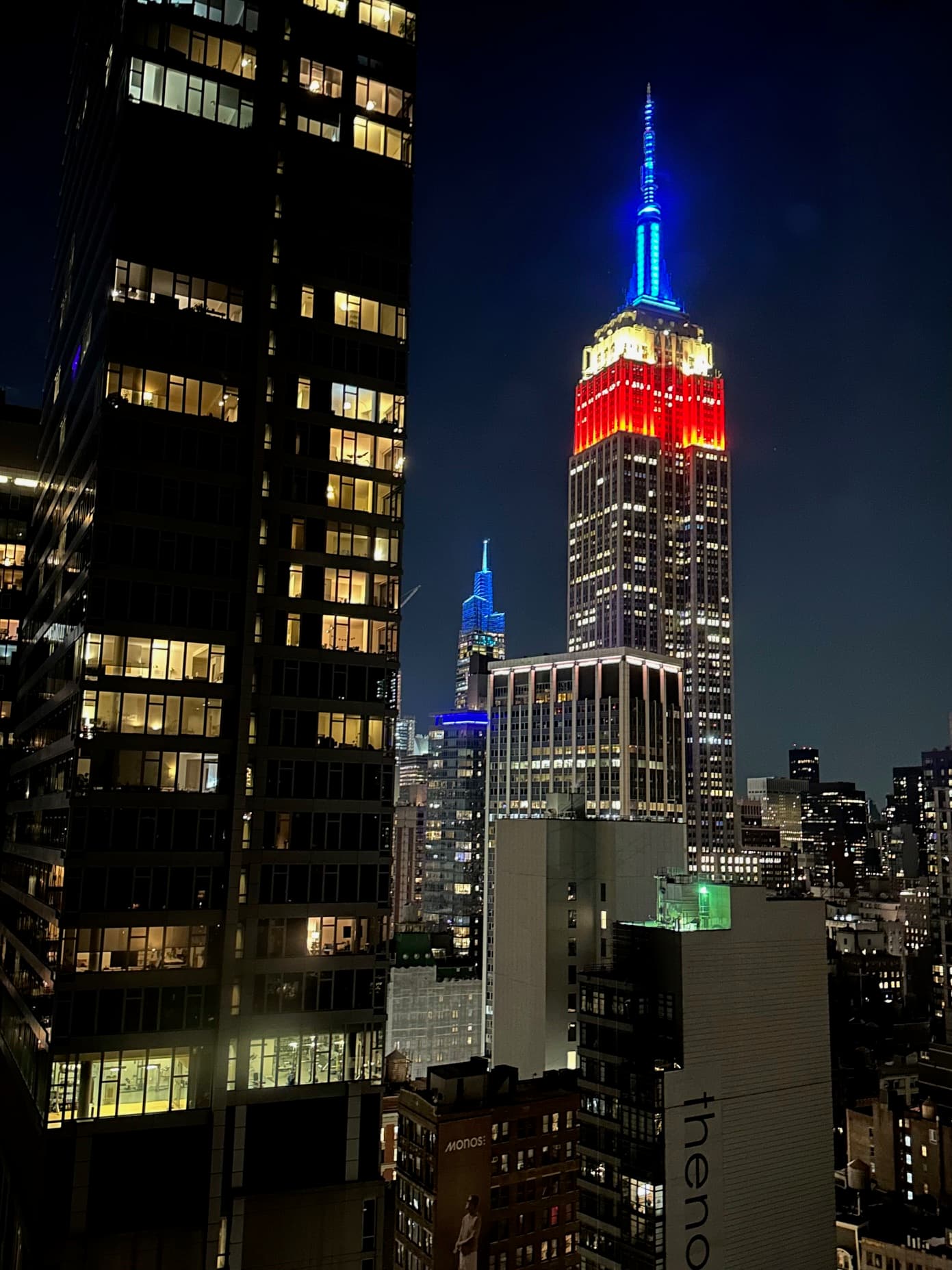 View of the Empire State Building lit up red, white and blue