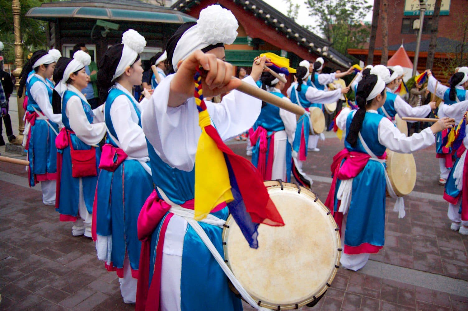 A group of people in dresses in a parade