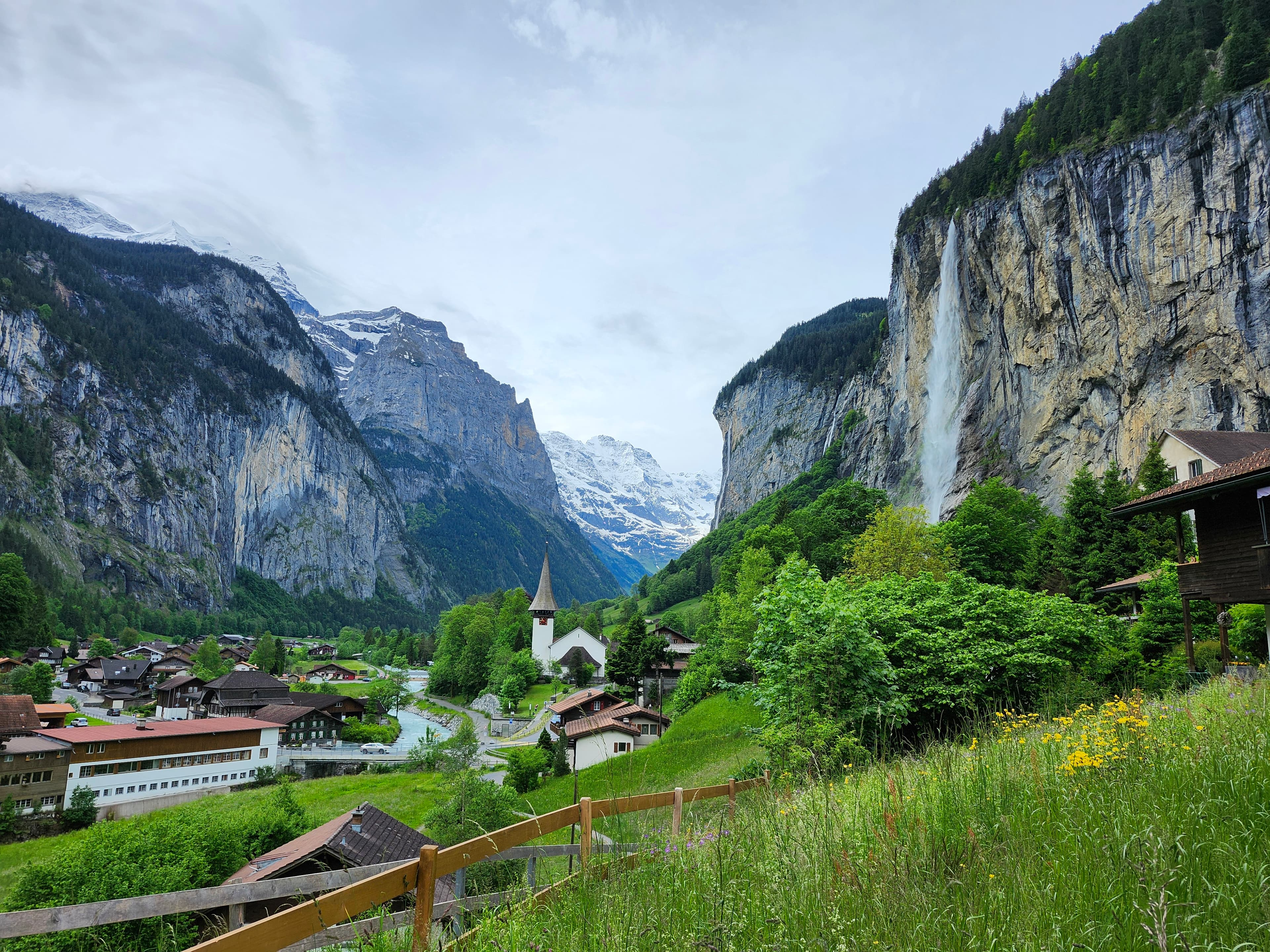View of a small town in a beautiful green valley surrounded by mountains