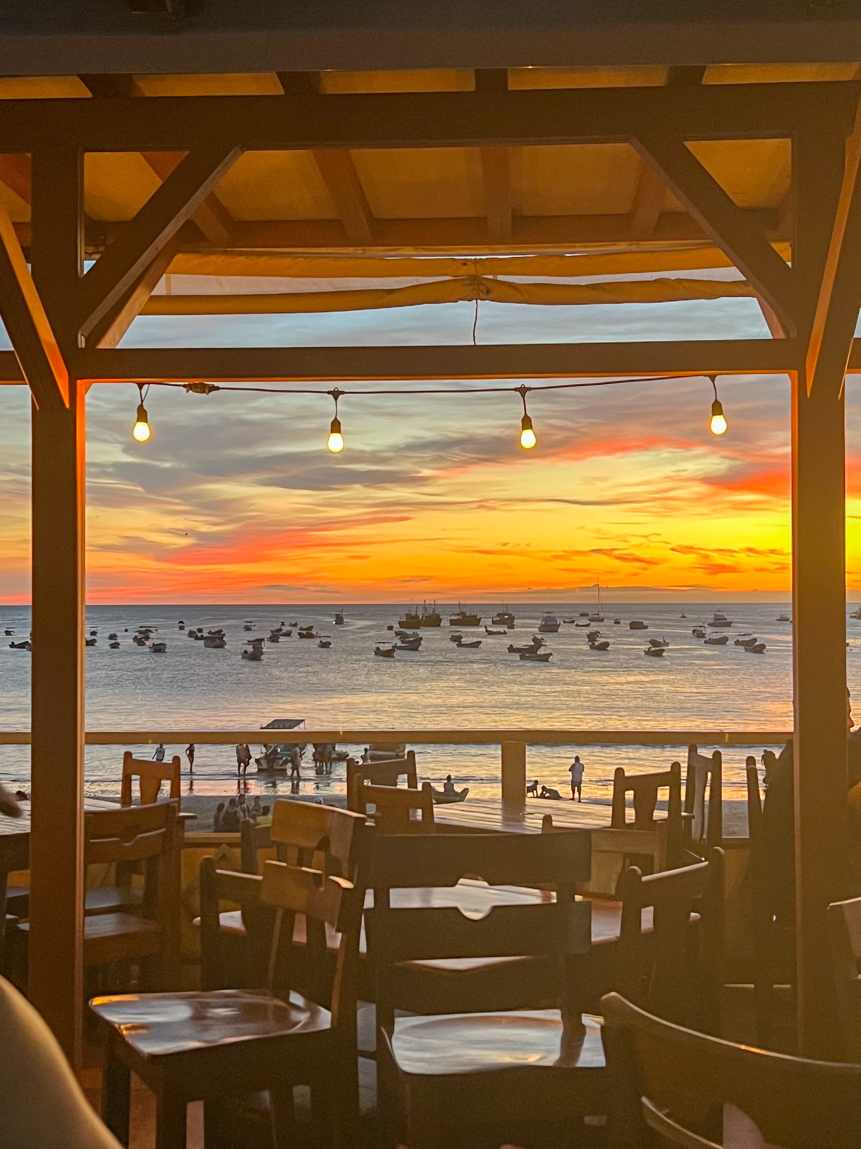 View of a beautiful sunset over the sea as seen from an open-air restaurant
