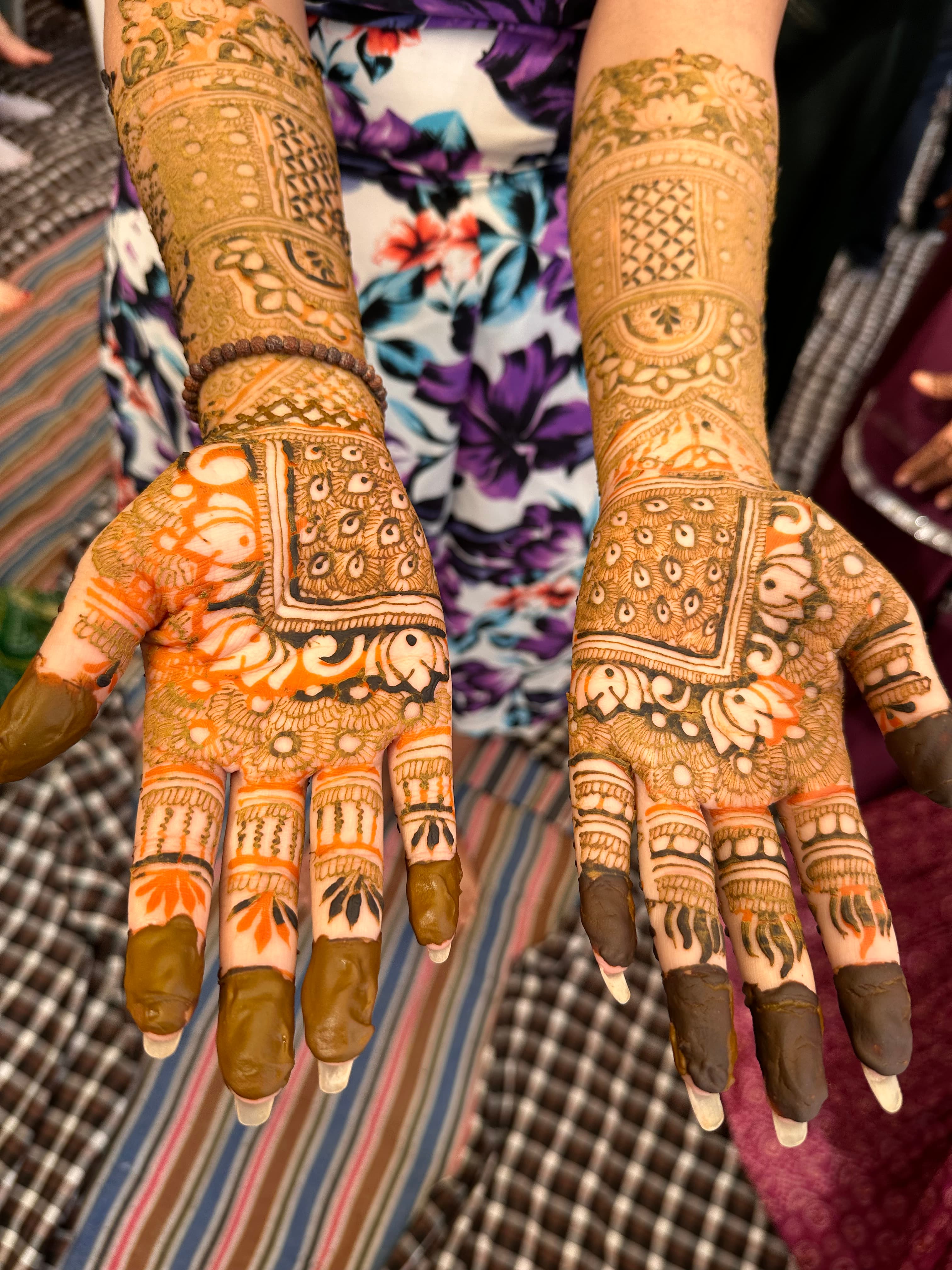 View of two hands covered in detailed henna tattoo