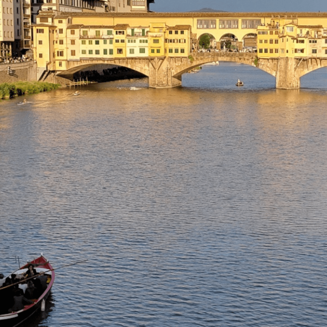 View of a bridge across a wide river glowing in the light of sunset