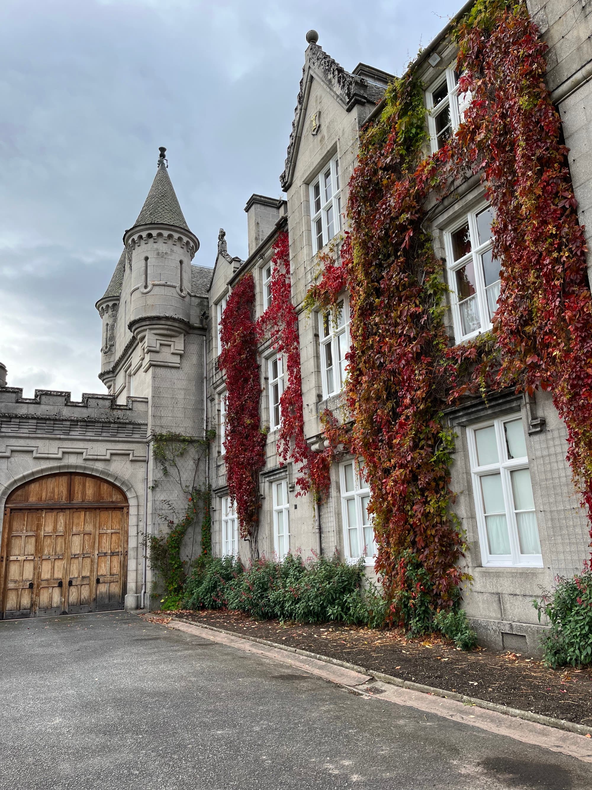 a castle with red ivy growing on the facade