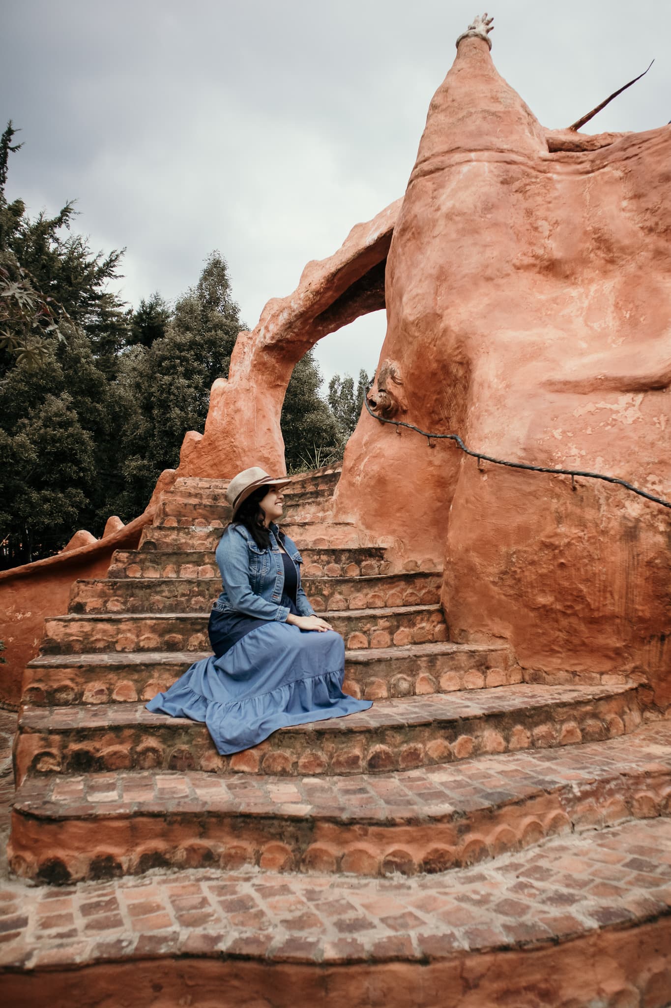 Travel Advisor Diana Morales sitting outside on stairs outside.