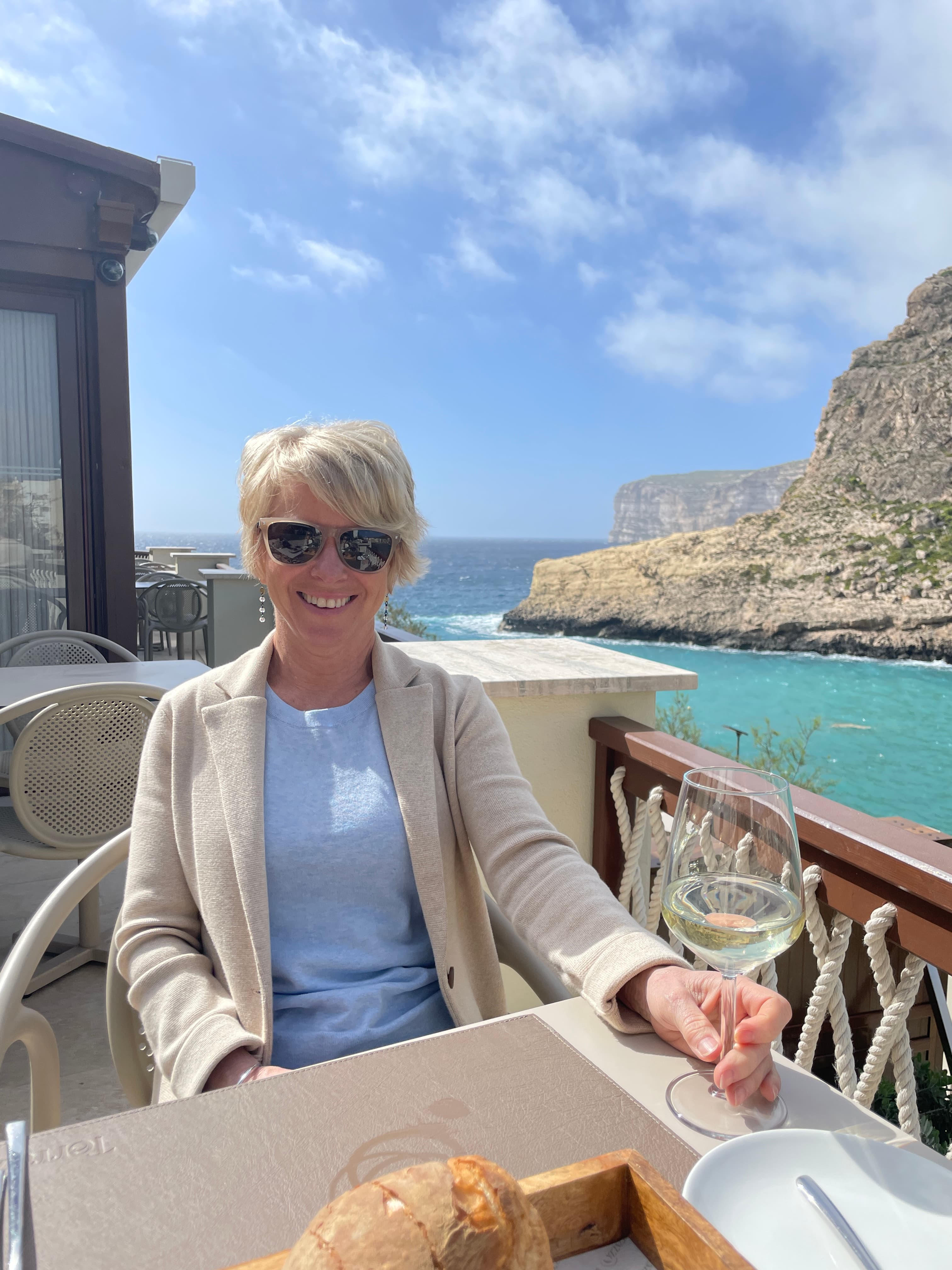 Travel advisor sitting in a restaurant beside the sea