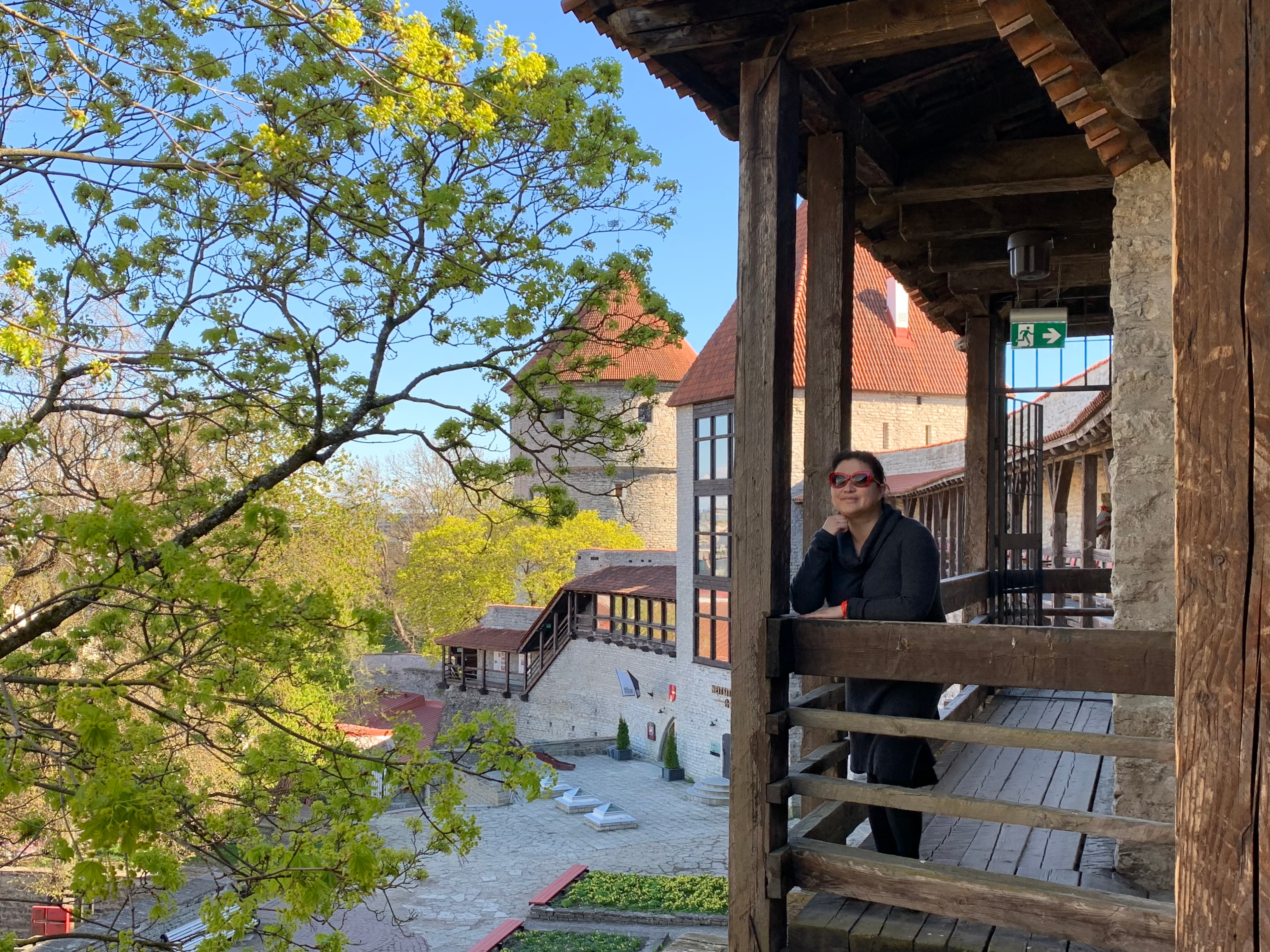 A woman posing on the balcony of a hut