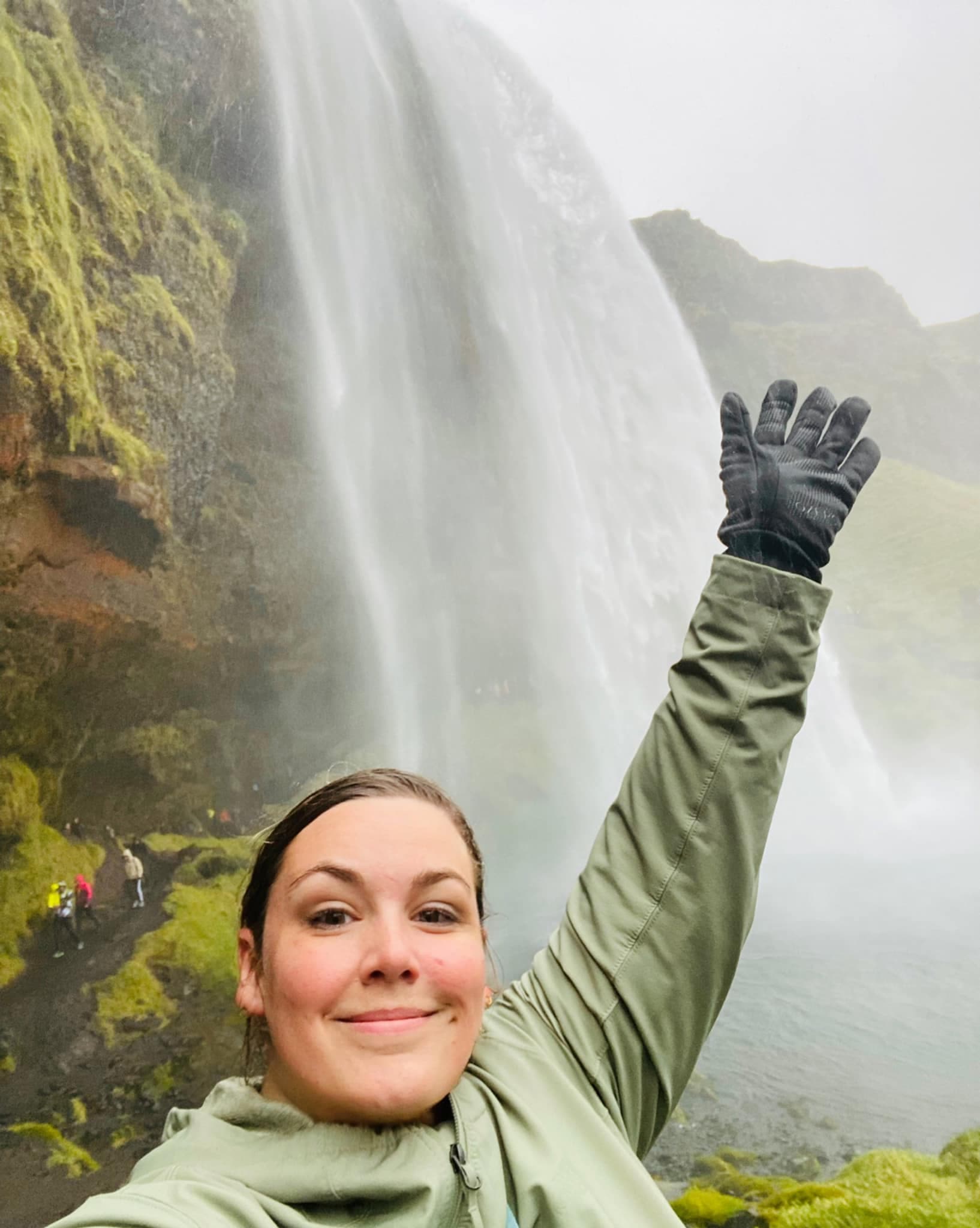 Travel advisor posing in front of a waterfall