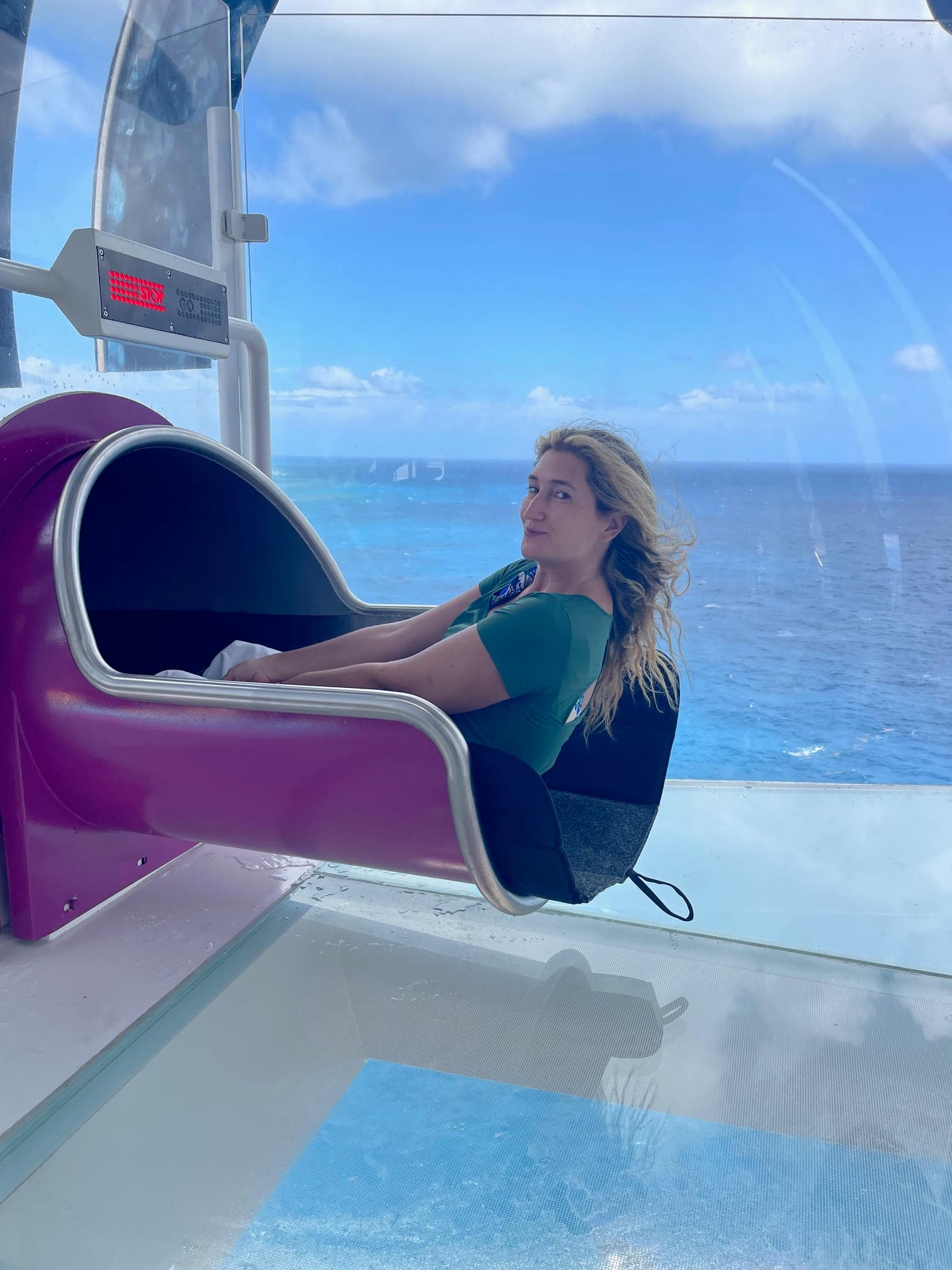 Flavia posing in a purple tube slide, about to take the plunge.