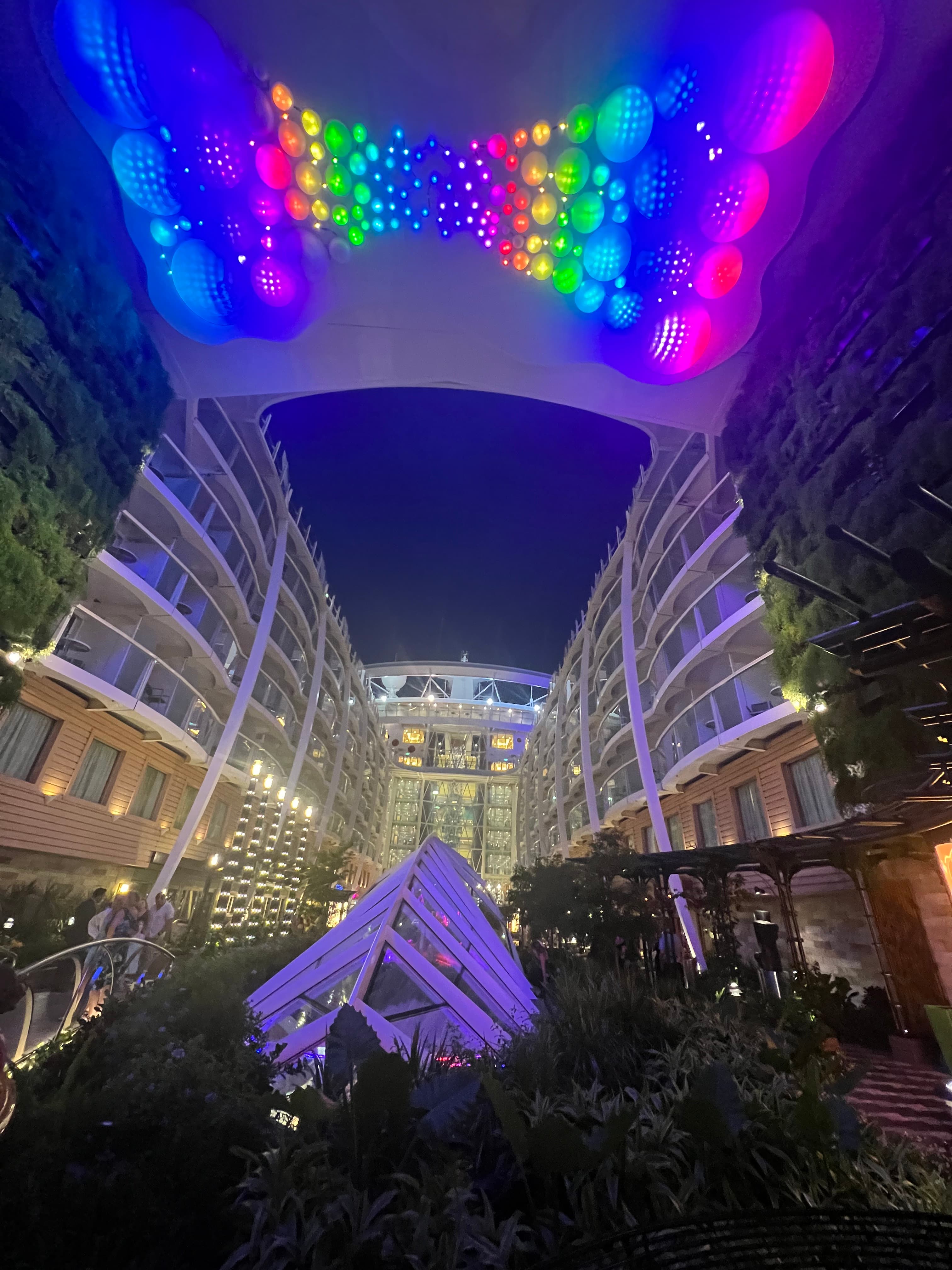 View of a rainbow themed light show on the roof of a building