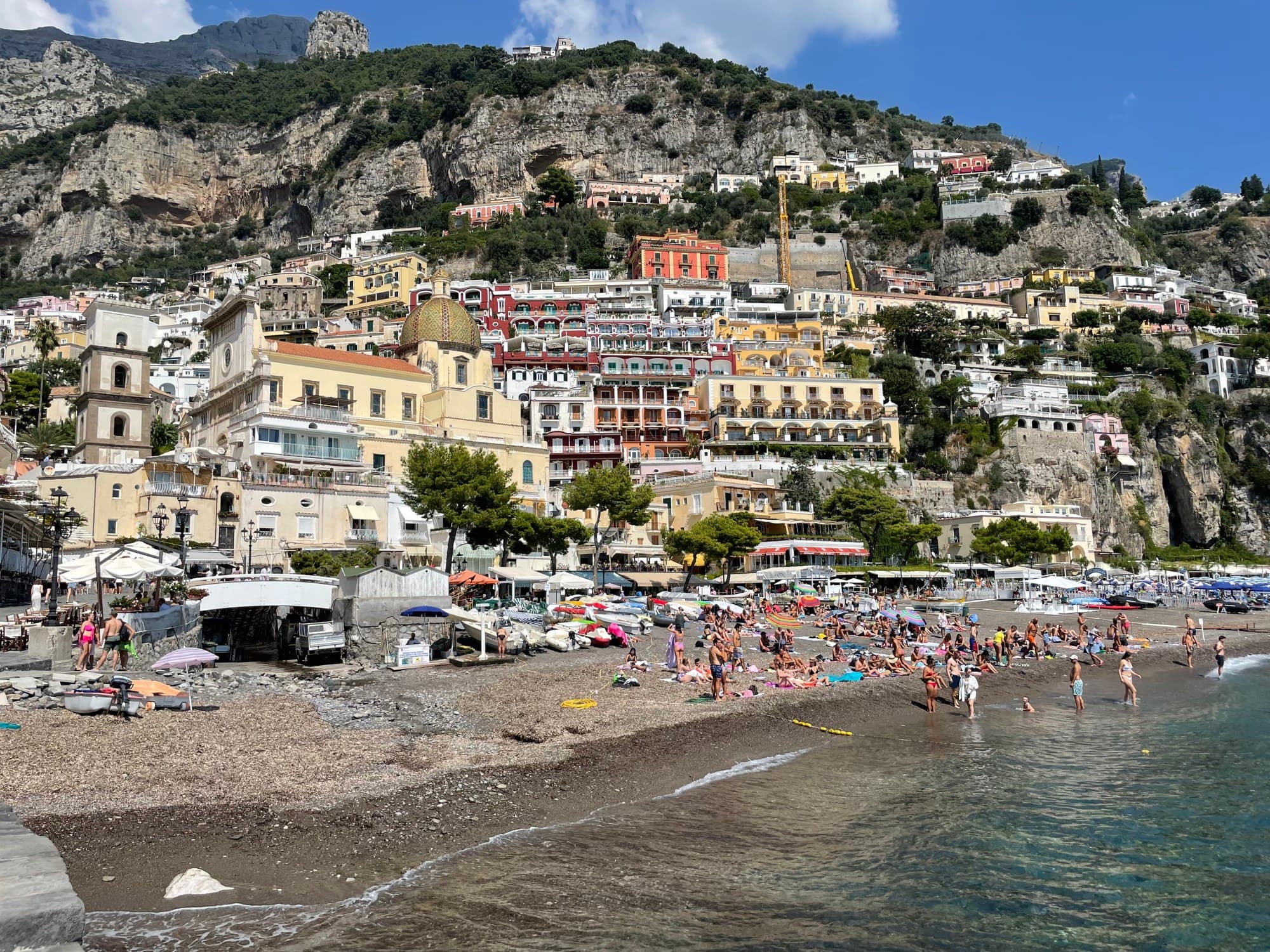Buildings and people on a beach.