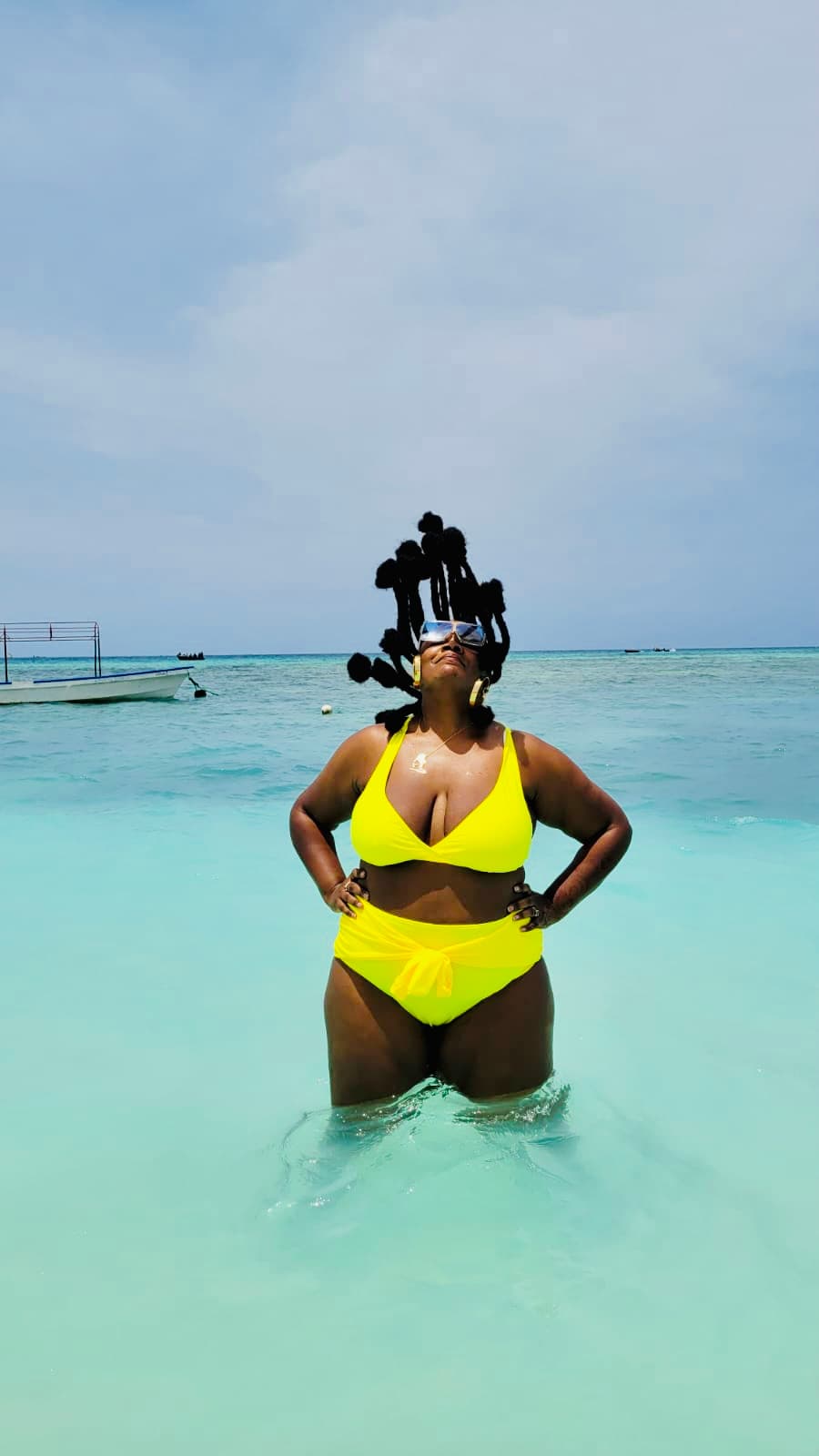 A woman in yellow swim suit in sea.