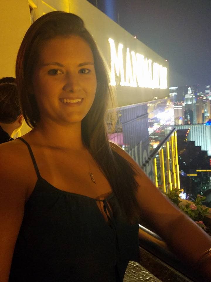 alyssa in black dress on balcony