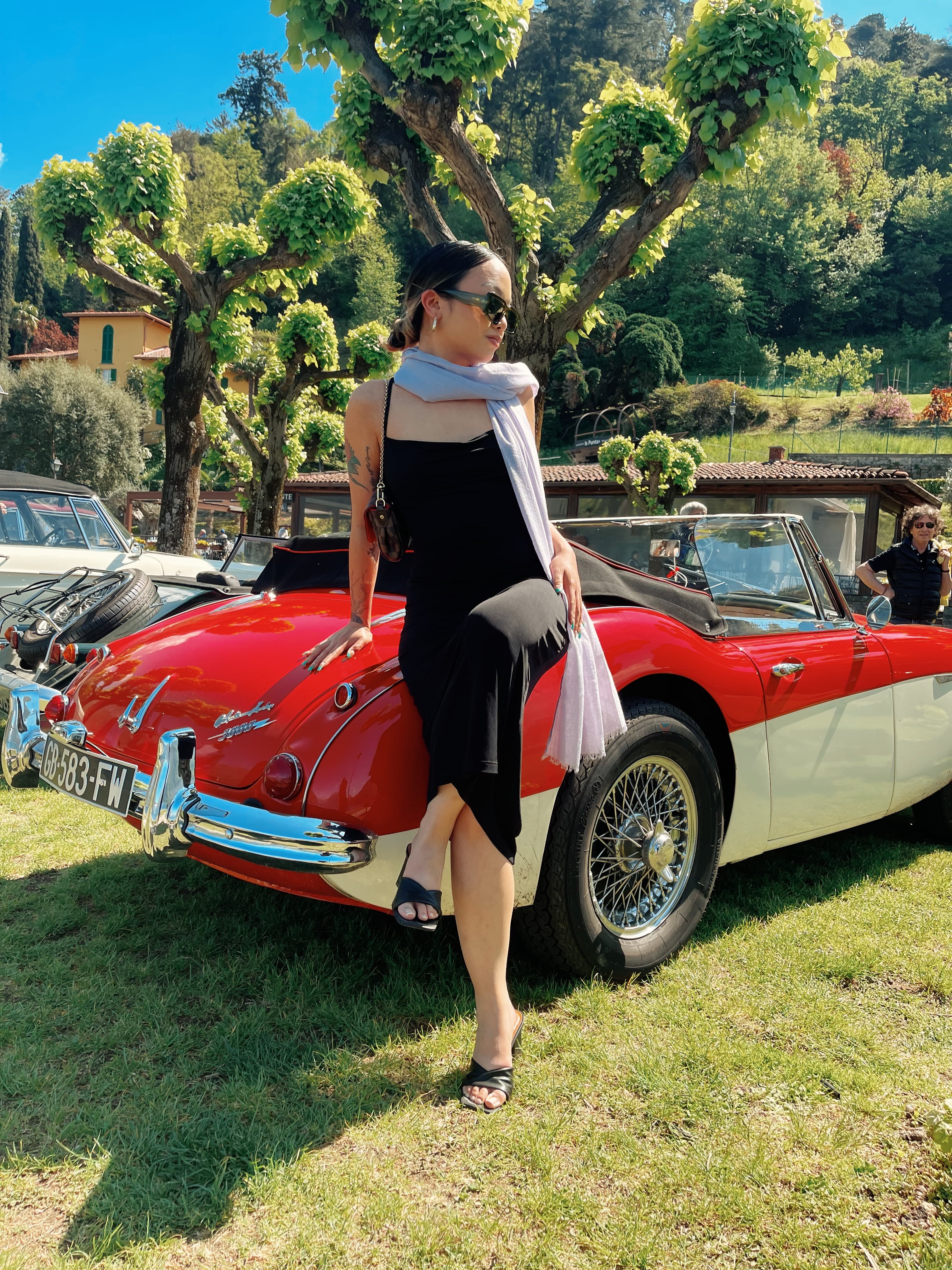 Travel advisor posing with a car