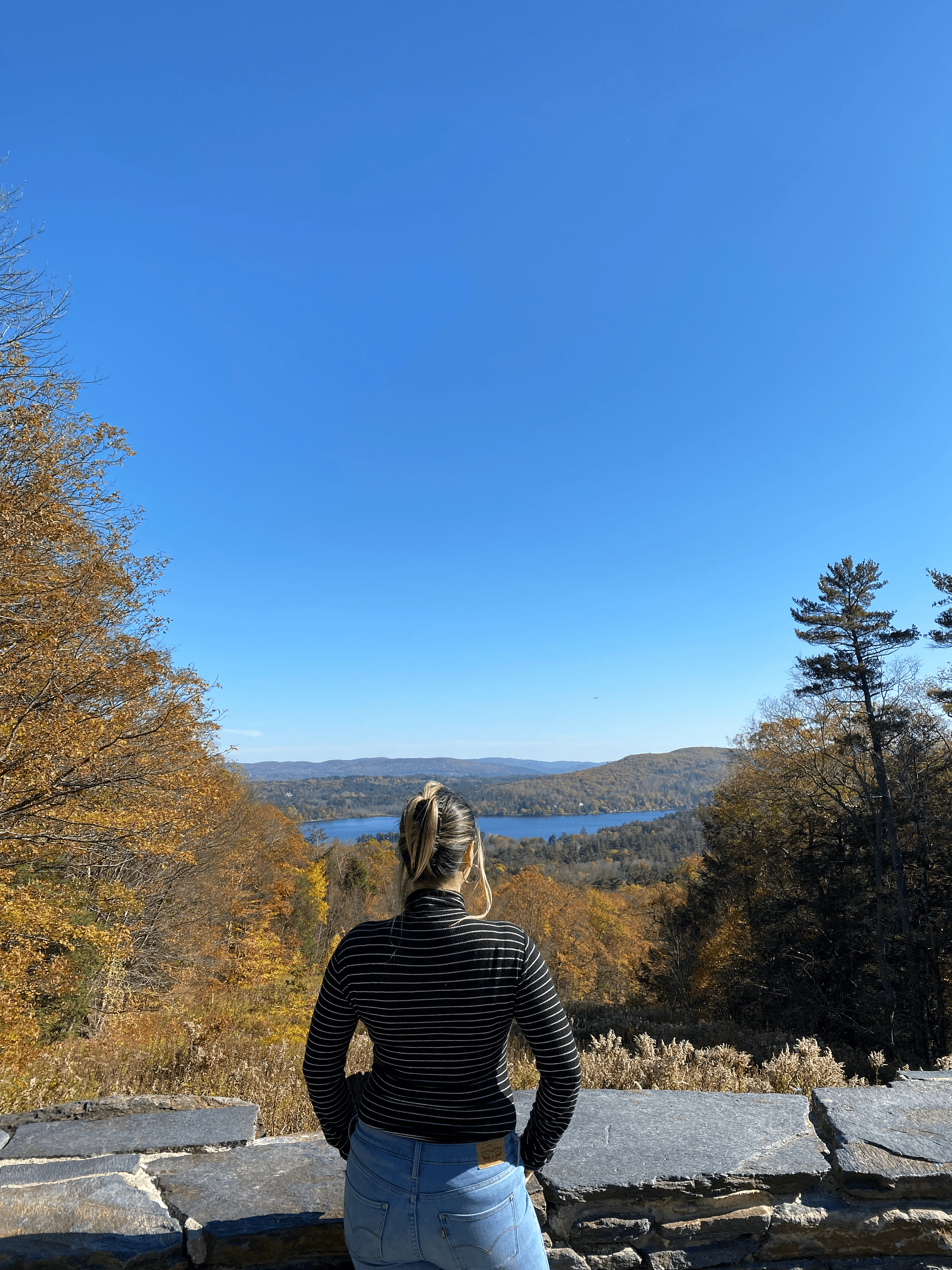 Picture of Kat Galoski wearing jeans and black shirt and looking at sky