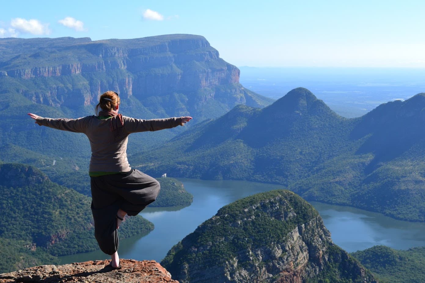 Travel advisor posing on a hill top