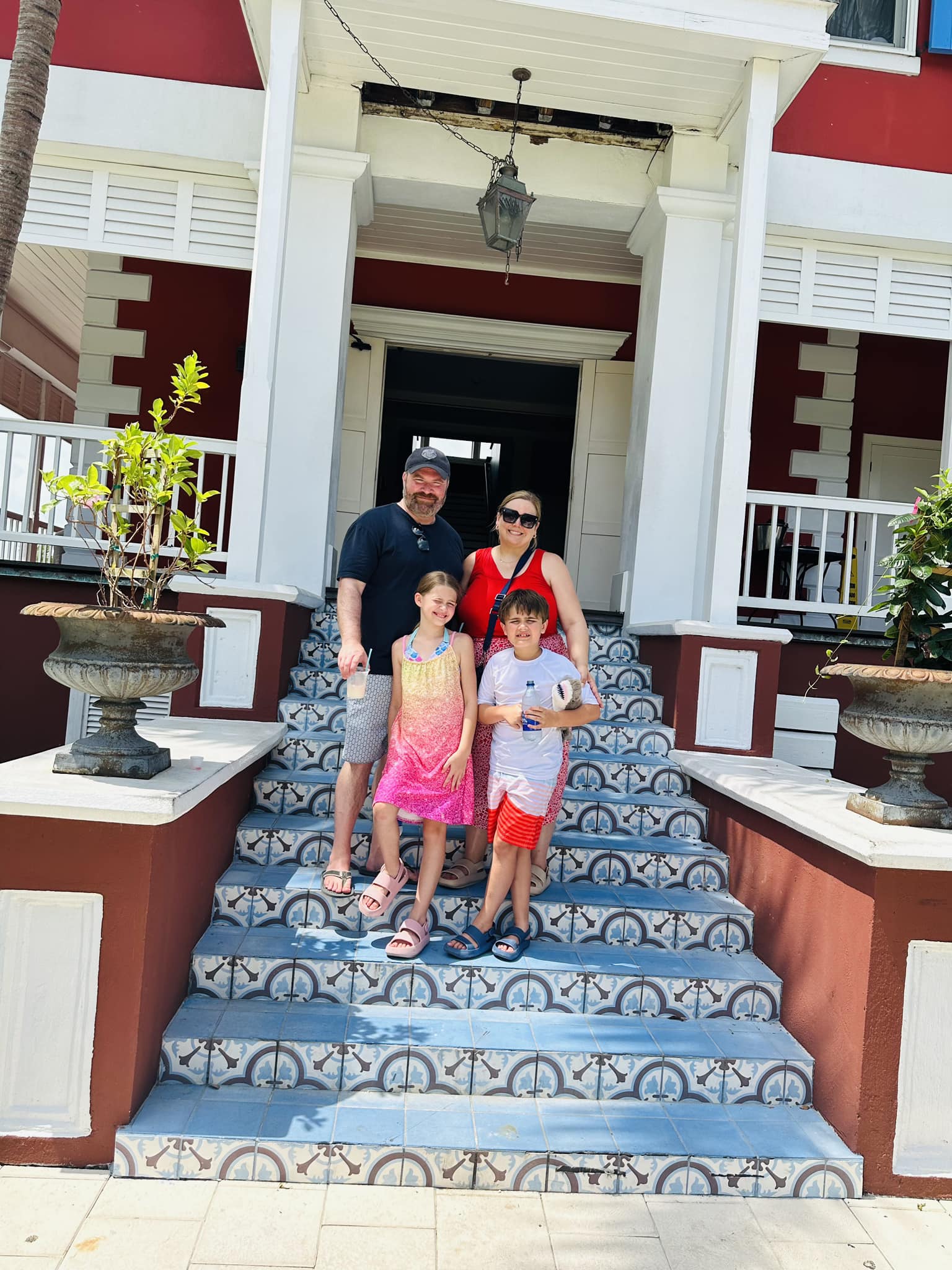 Travel advisor posing with family standing on entrance stairs