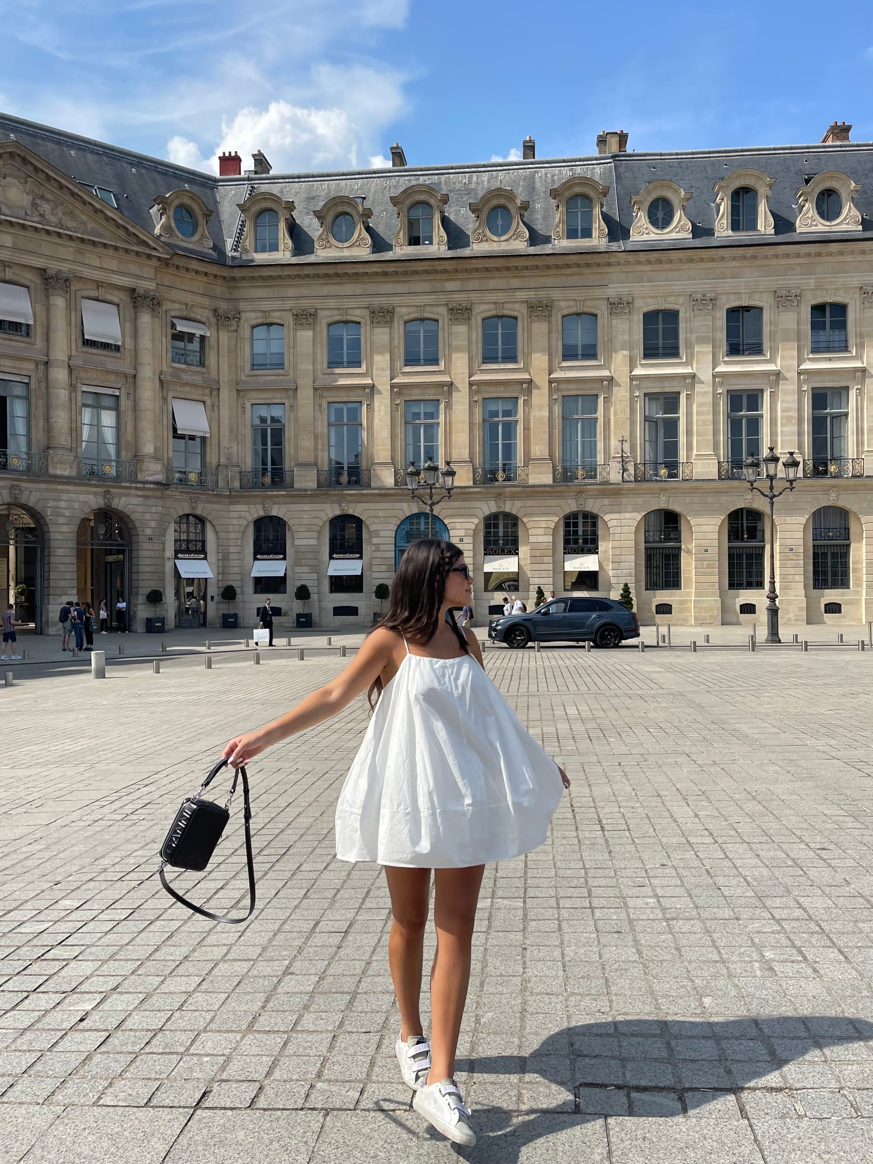Picture of Sophie in white dress at Hotel de Vendôme on a sunny day