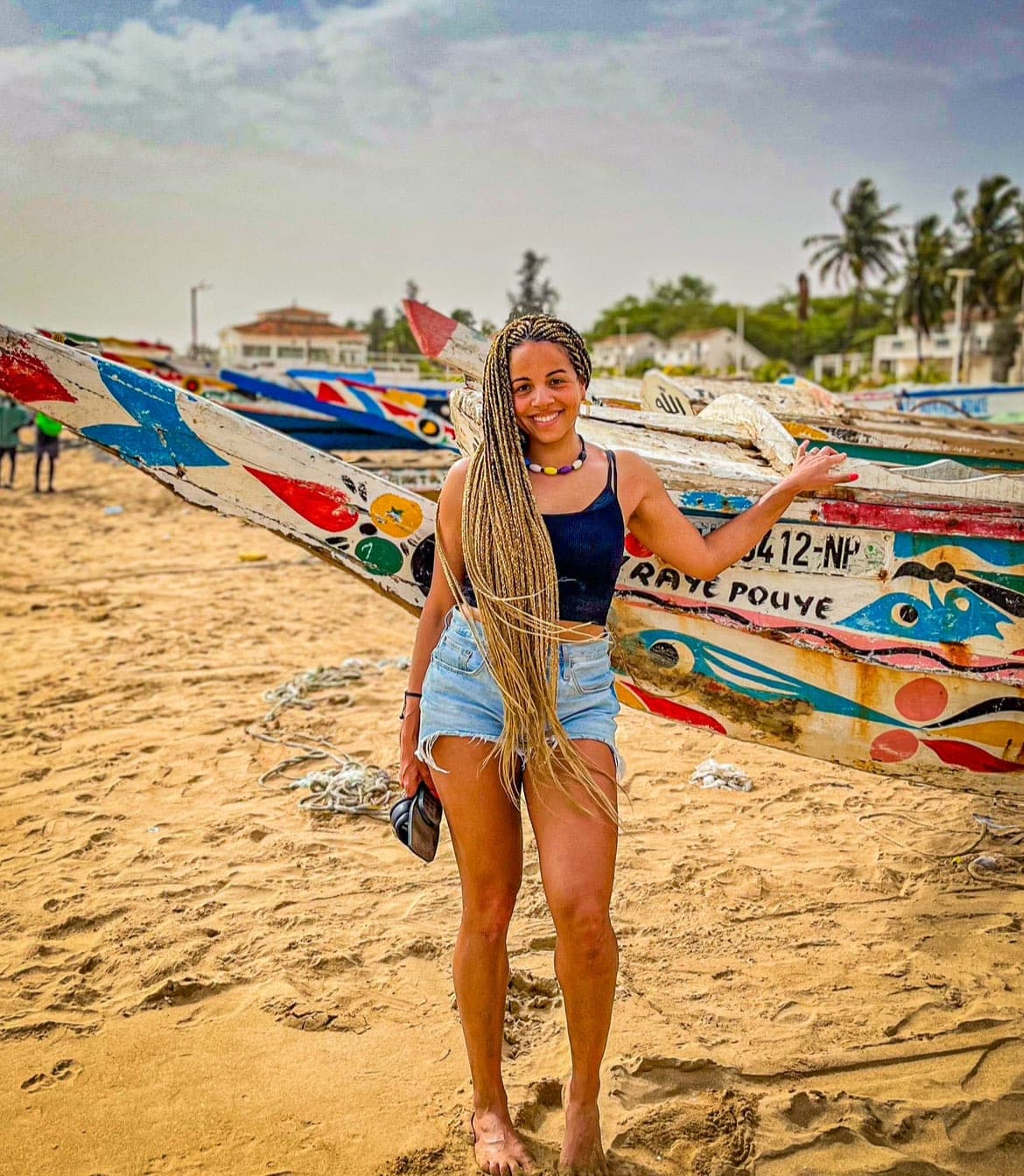 Elizabeth Jones on the beach with boats in the background