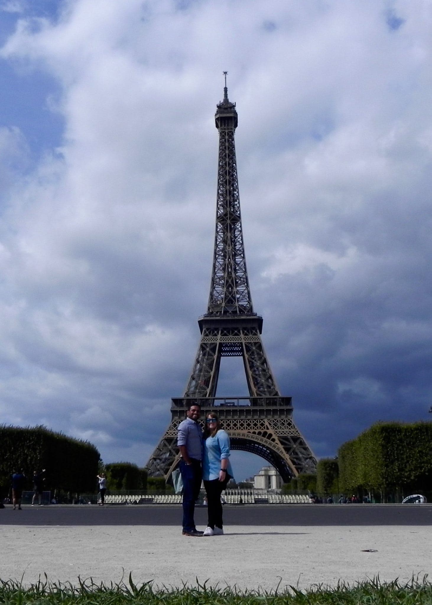 Travel advisor Bijoy standing in front of the Eiffel Tower with female companion