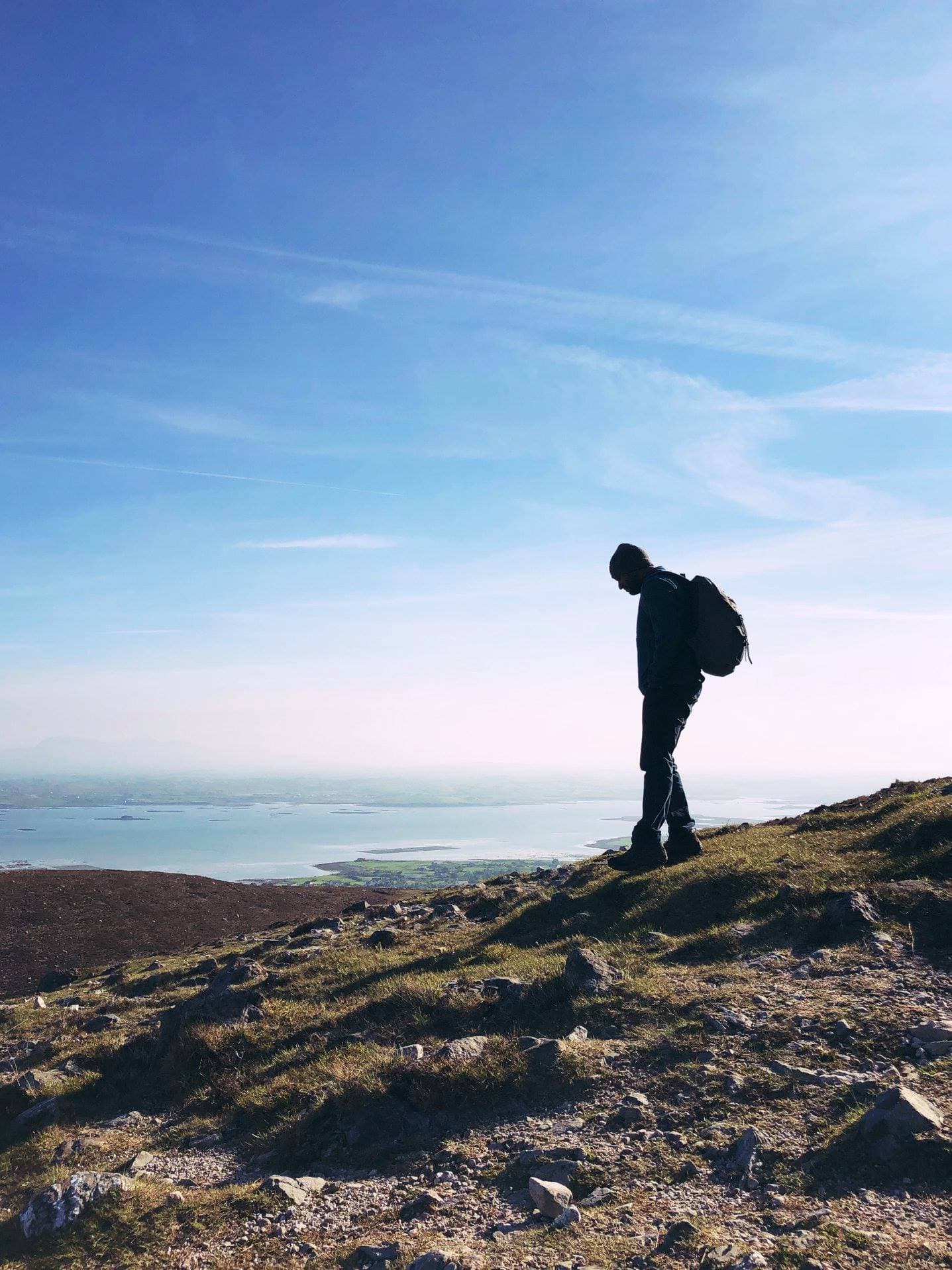 Travel advisor Bijoy hiking on a hill high above a view of the ocean