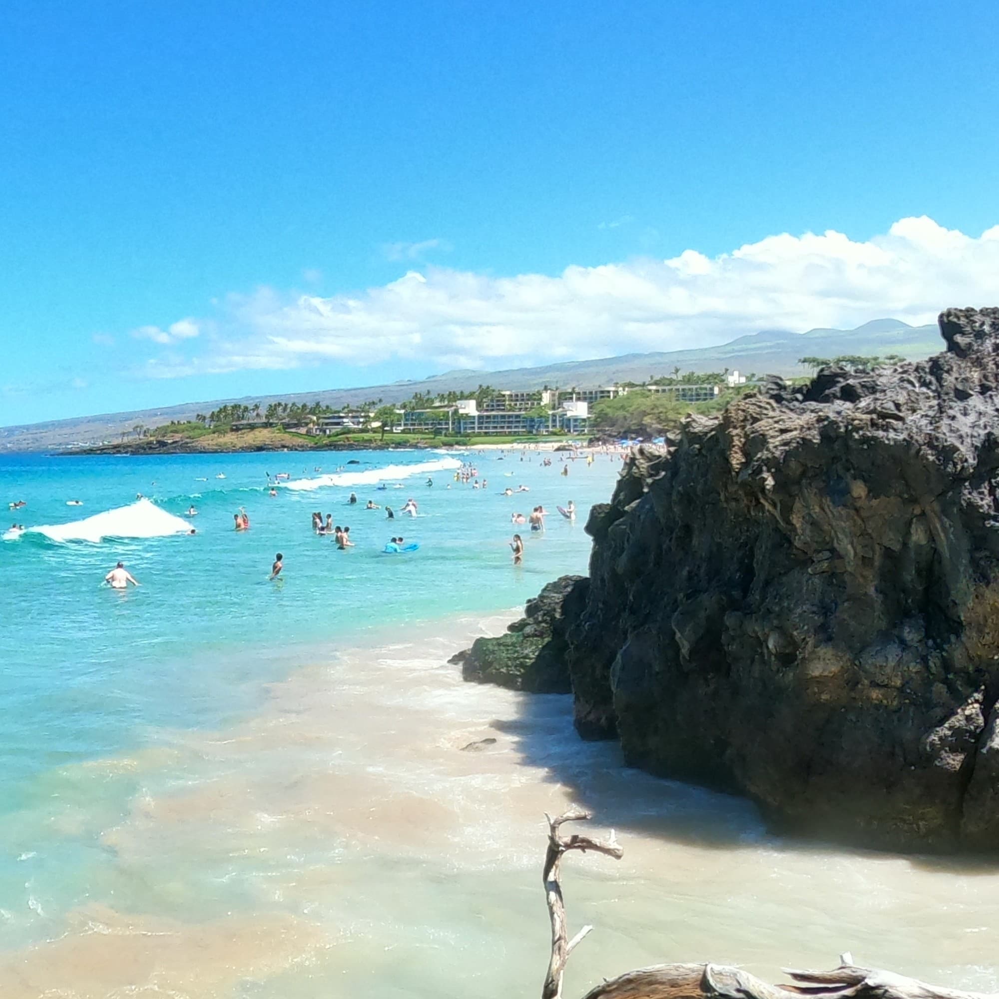 A far view of the beach filled with people.