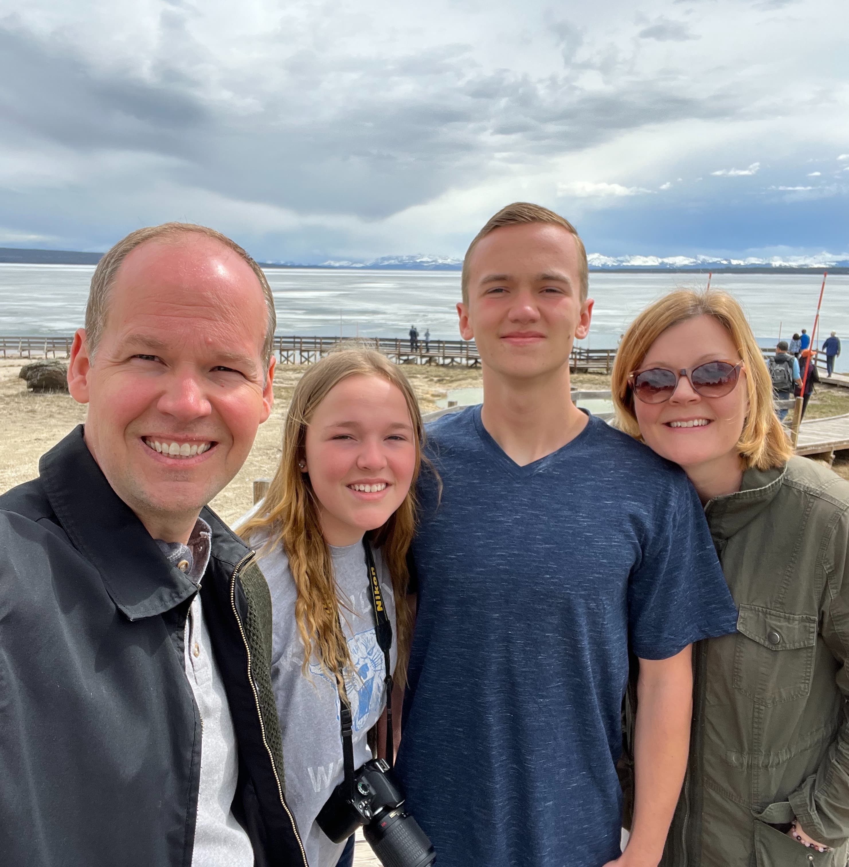 A family smiling for a selfie photo