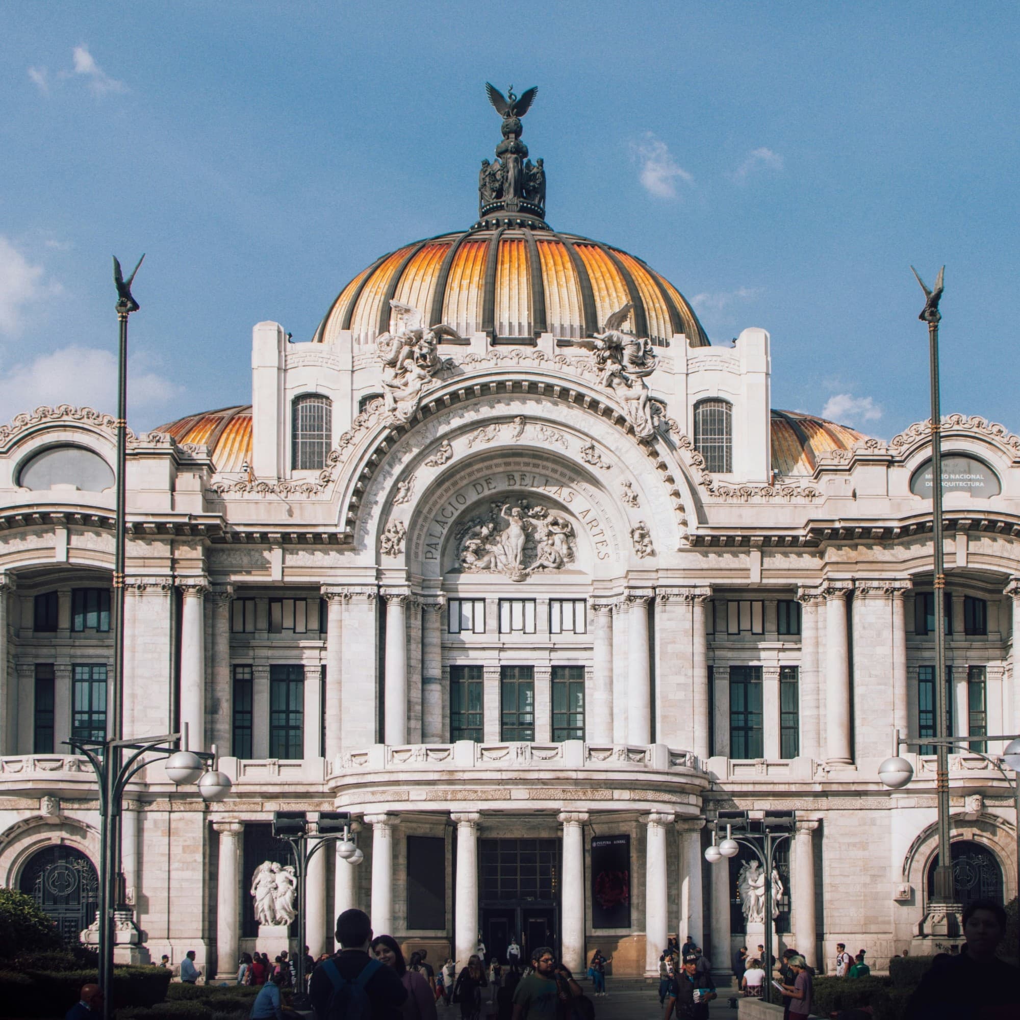 People walking near white concrete building during daytime.
