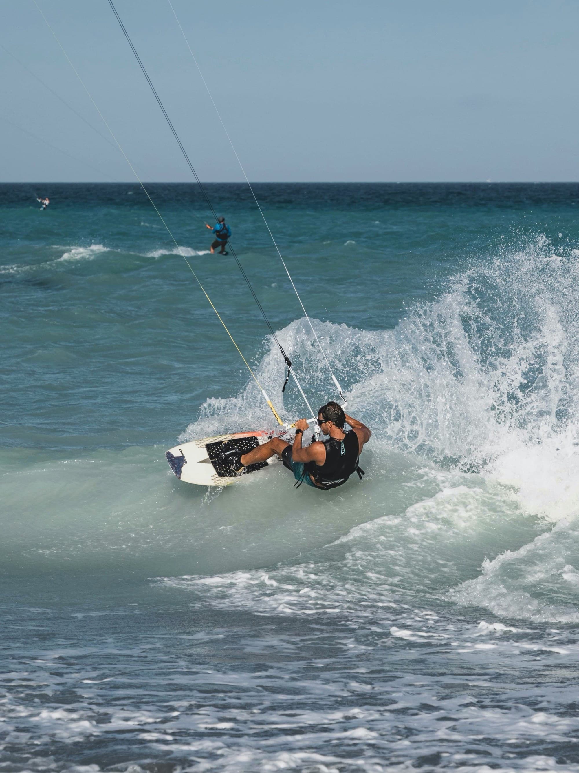 A person wakeboarding on the water with a big wake.