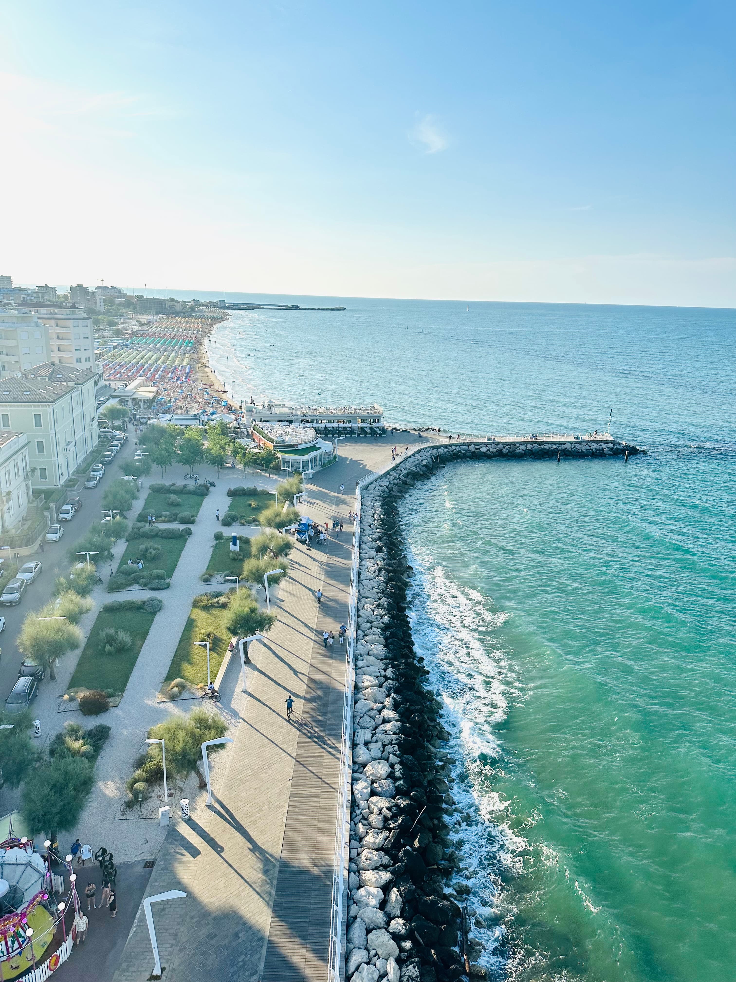 A view of the shore with clear blue water.
