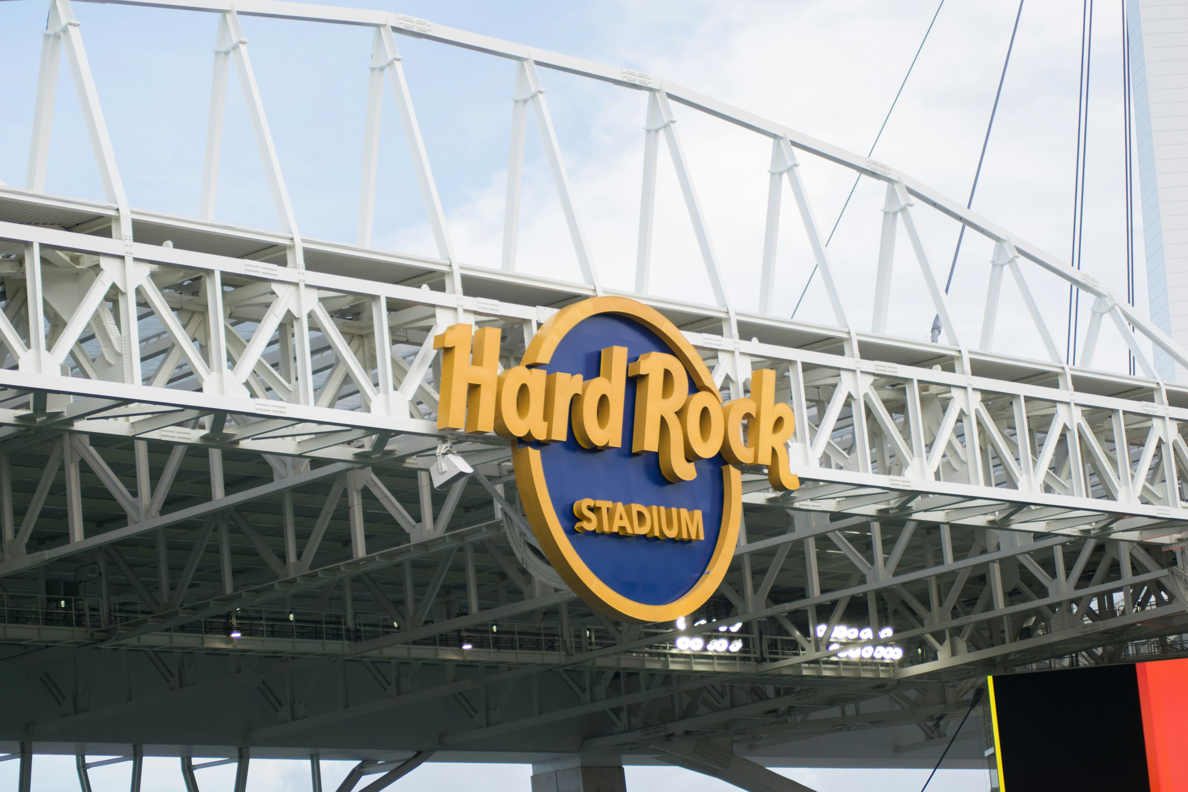 The exterior of Hard Rock Stadium in Miami, with a blue and yellow sign.