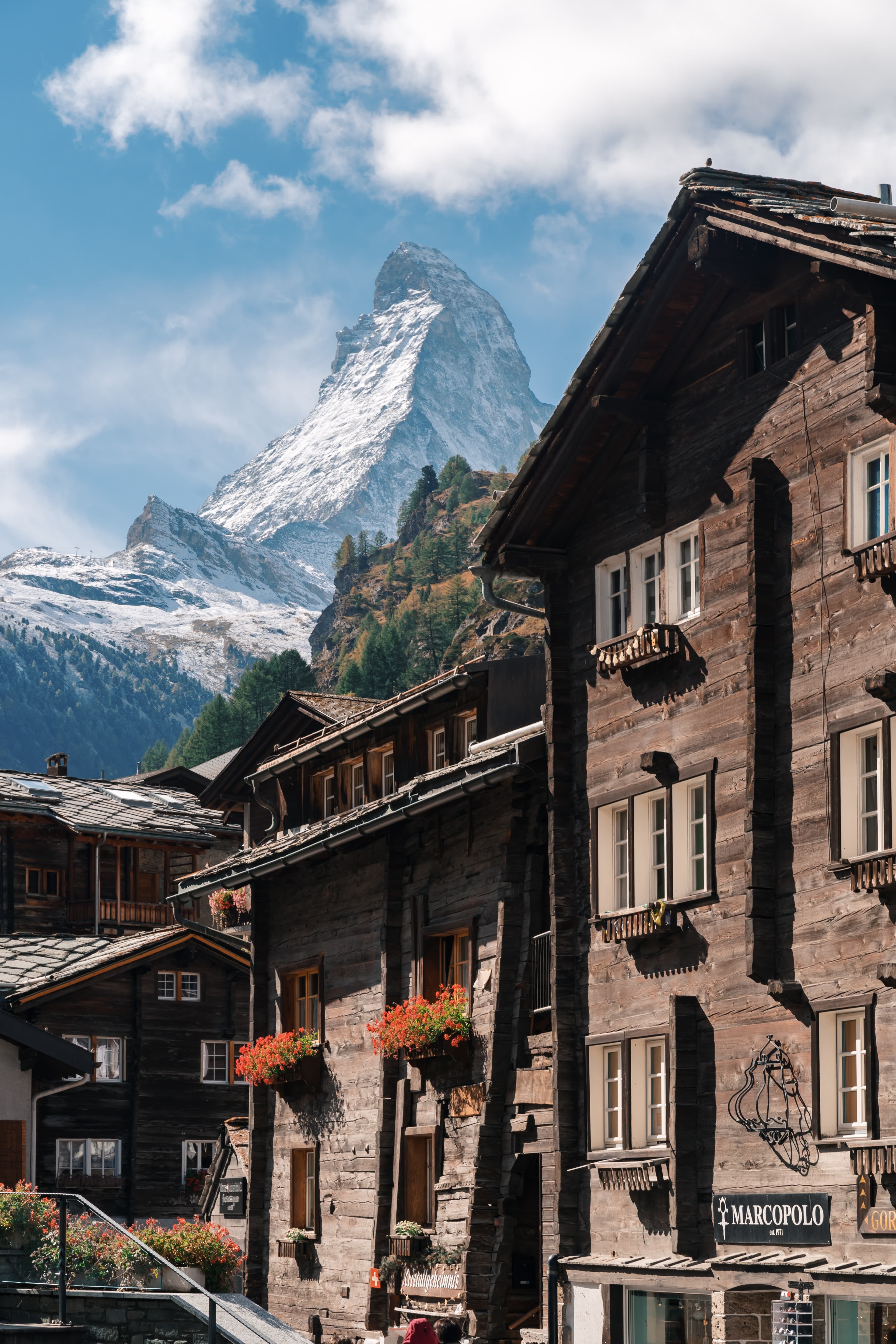 wood houses with mountains in the background during daytime
