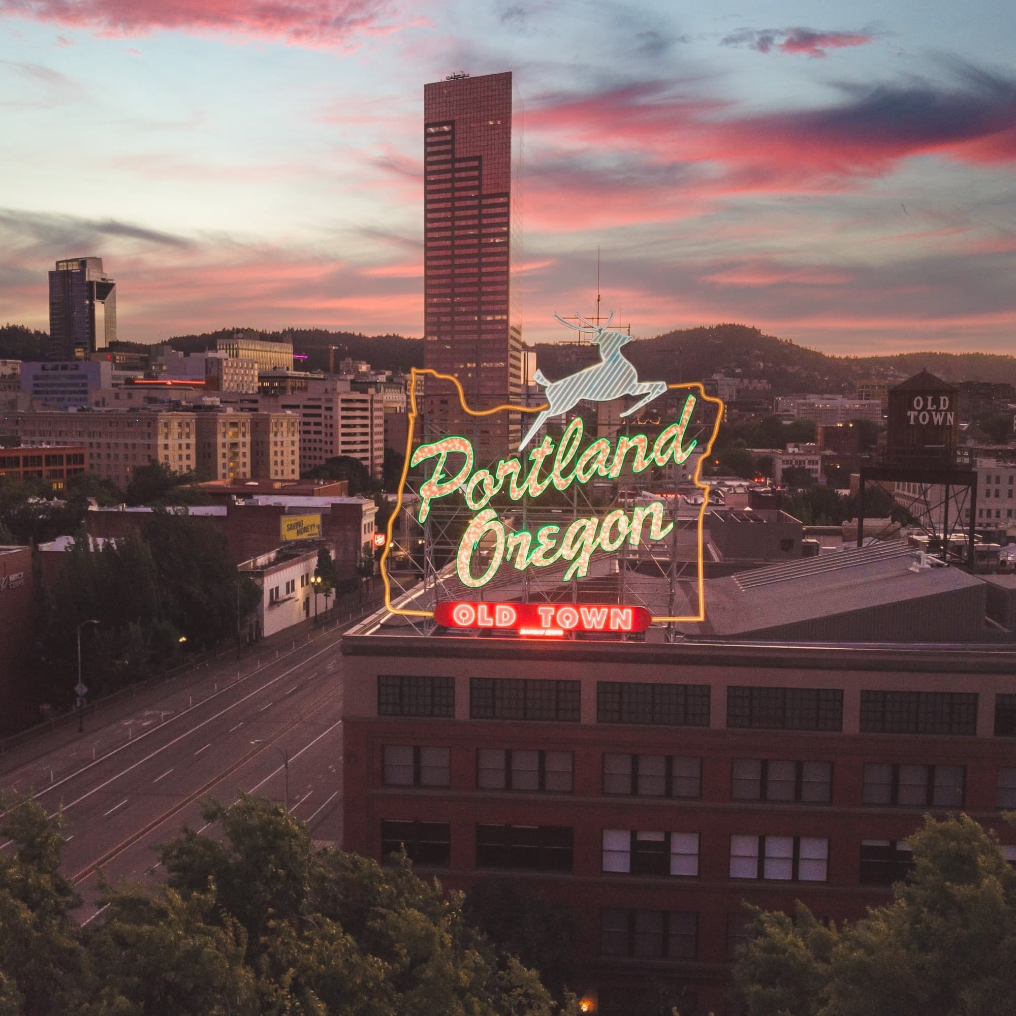 A large neon sign on top of a building.