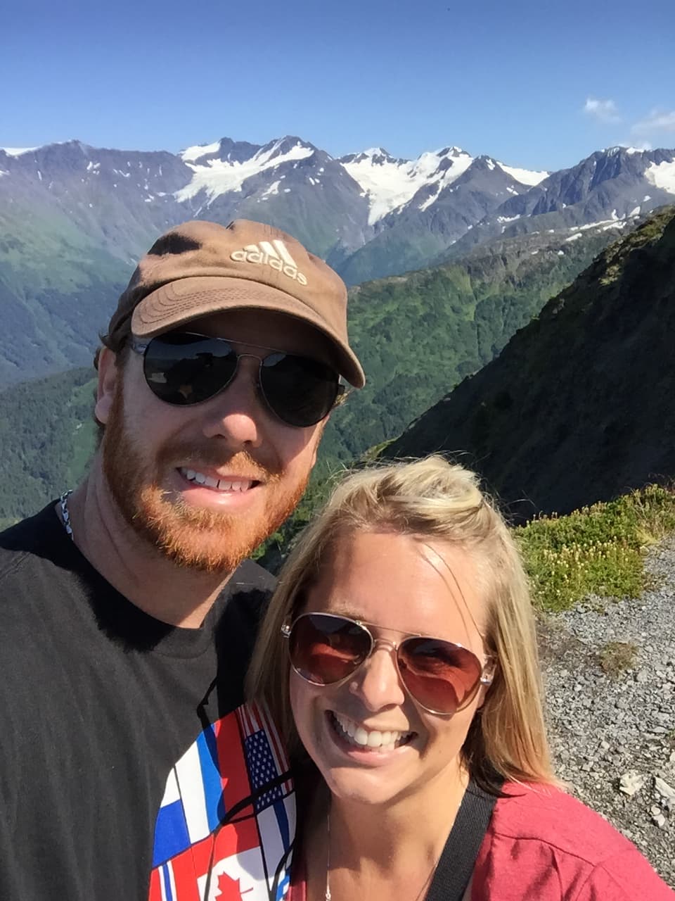 A couple with mountains at the back.