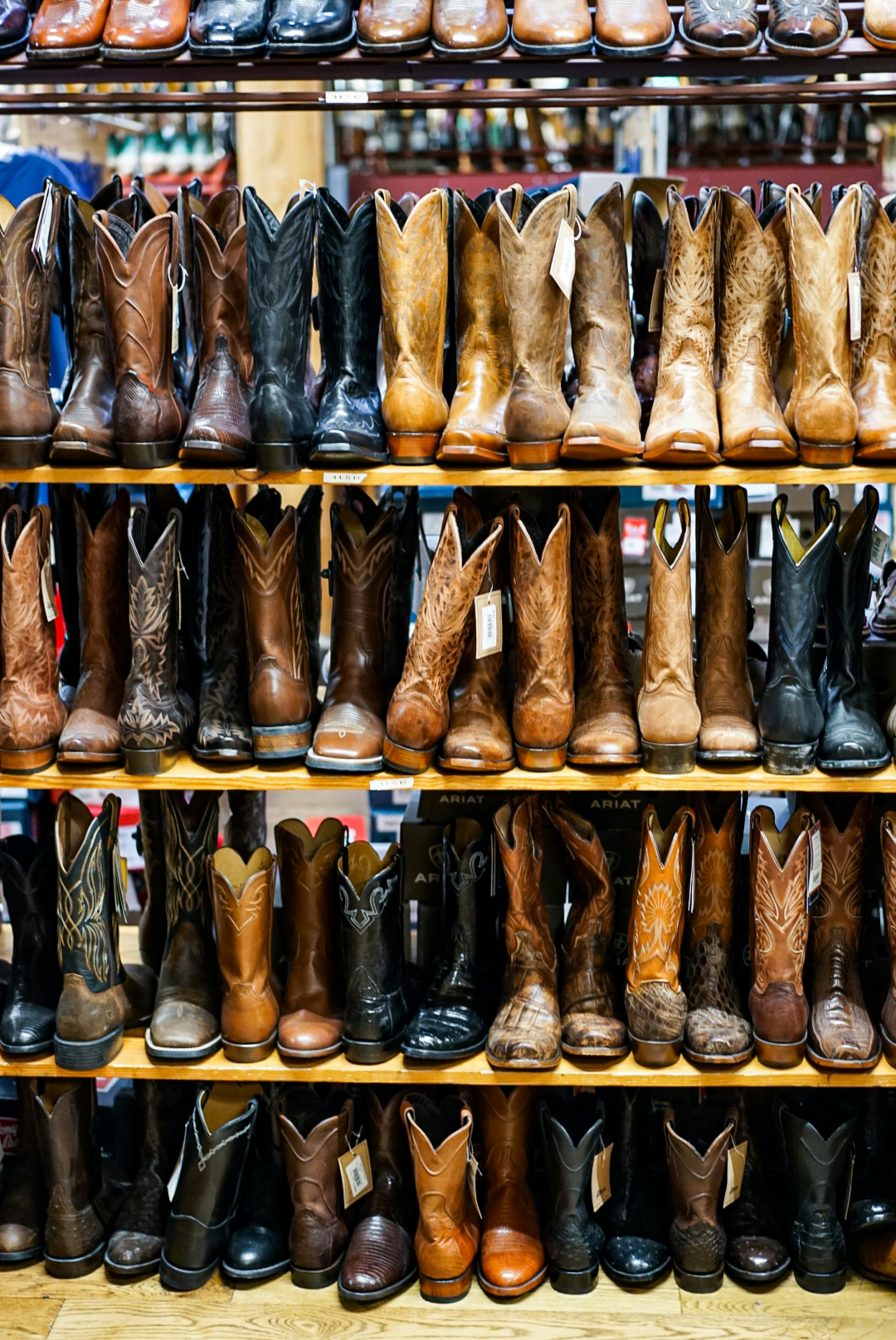Shelves full of western boots displayed in a store.
