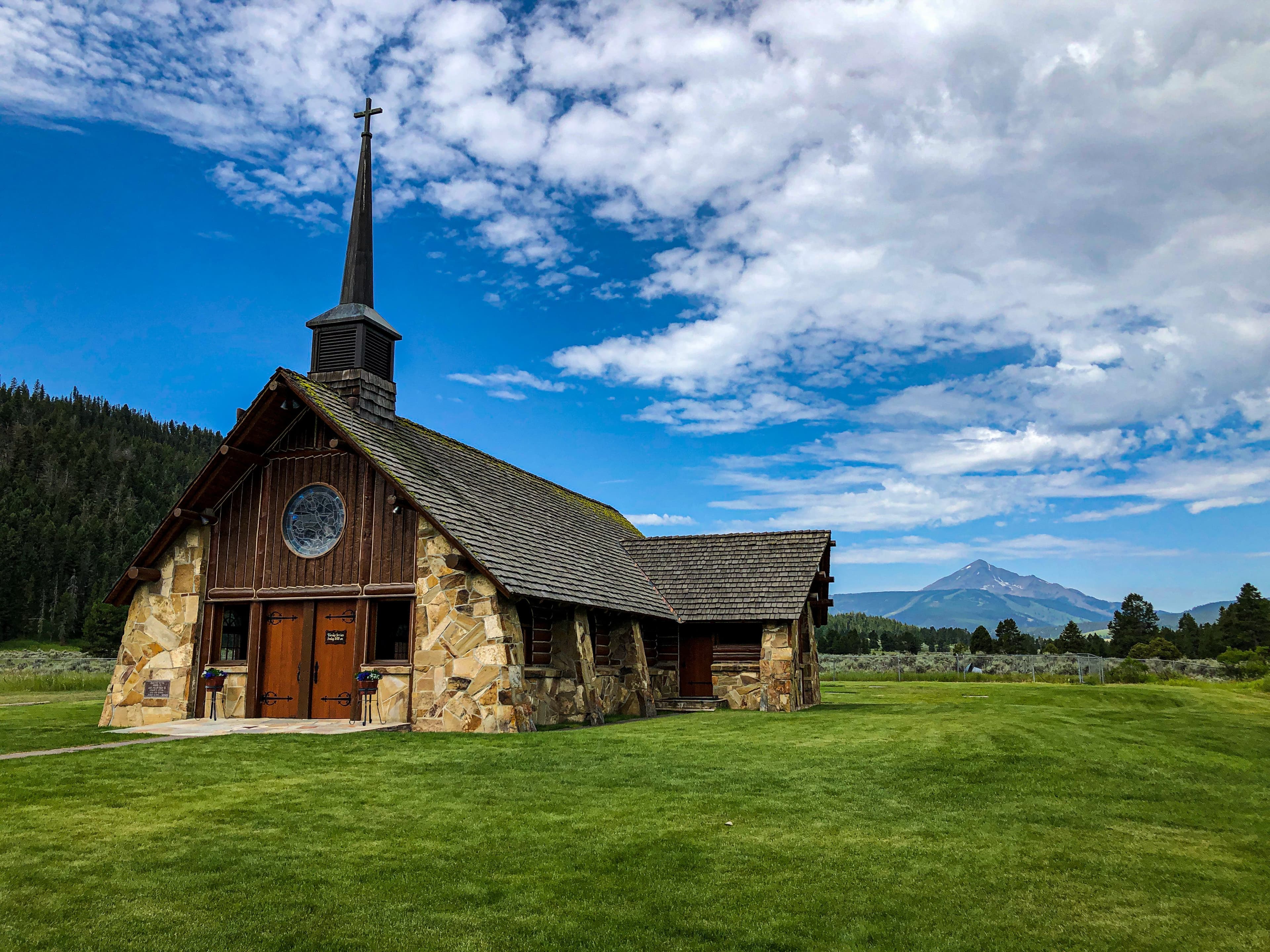 A hut with steeple in green mountains.